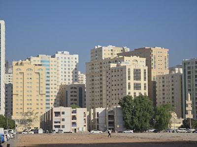 A city with tall buildings and a sandy beach
