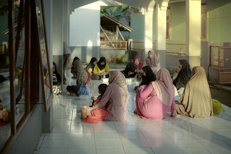 A group of women sitting on the floor of a building