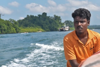 A man in an orange shirt on a boat