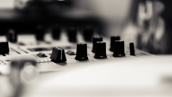 A close up of a sound board with many knobs