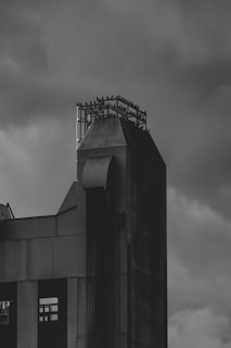A black and white photo of a building with a clock tower