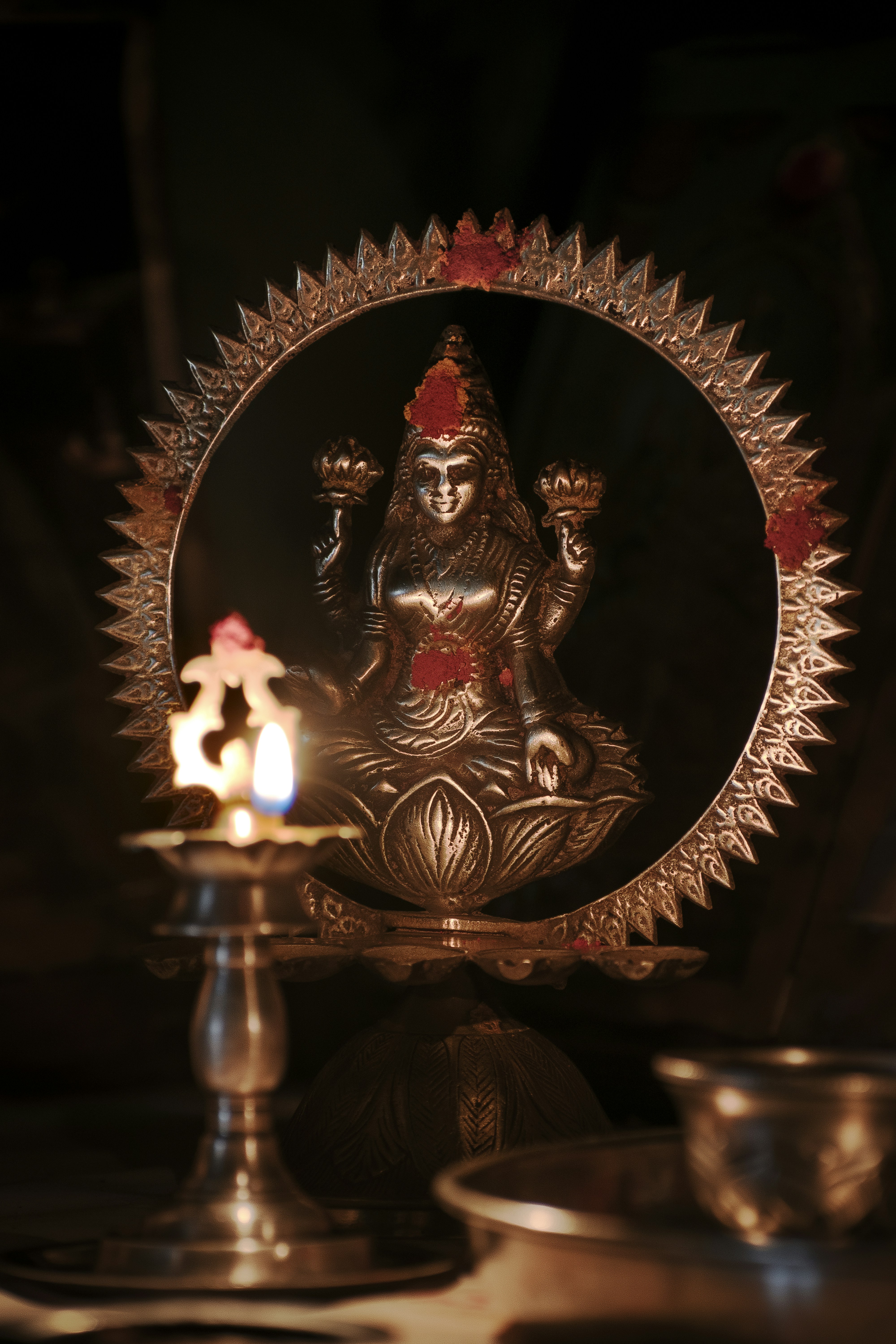 A statue of a person with a candle in front of it