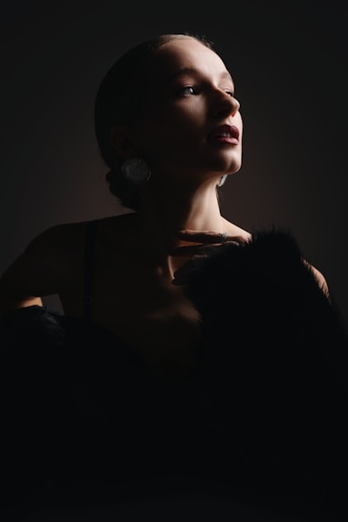 A woman in a dark room with a cat