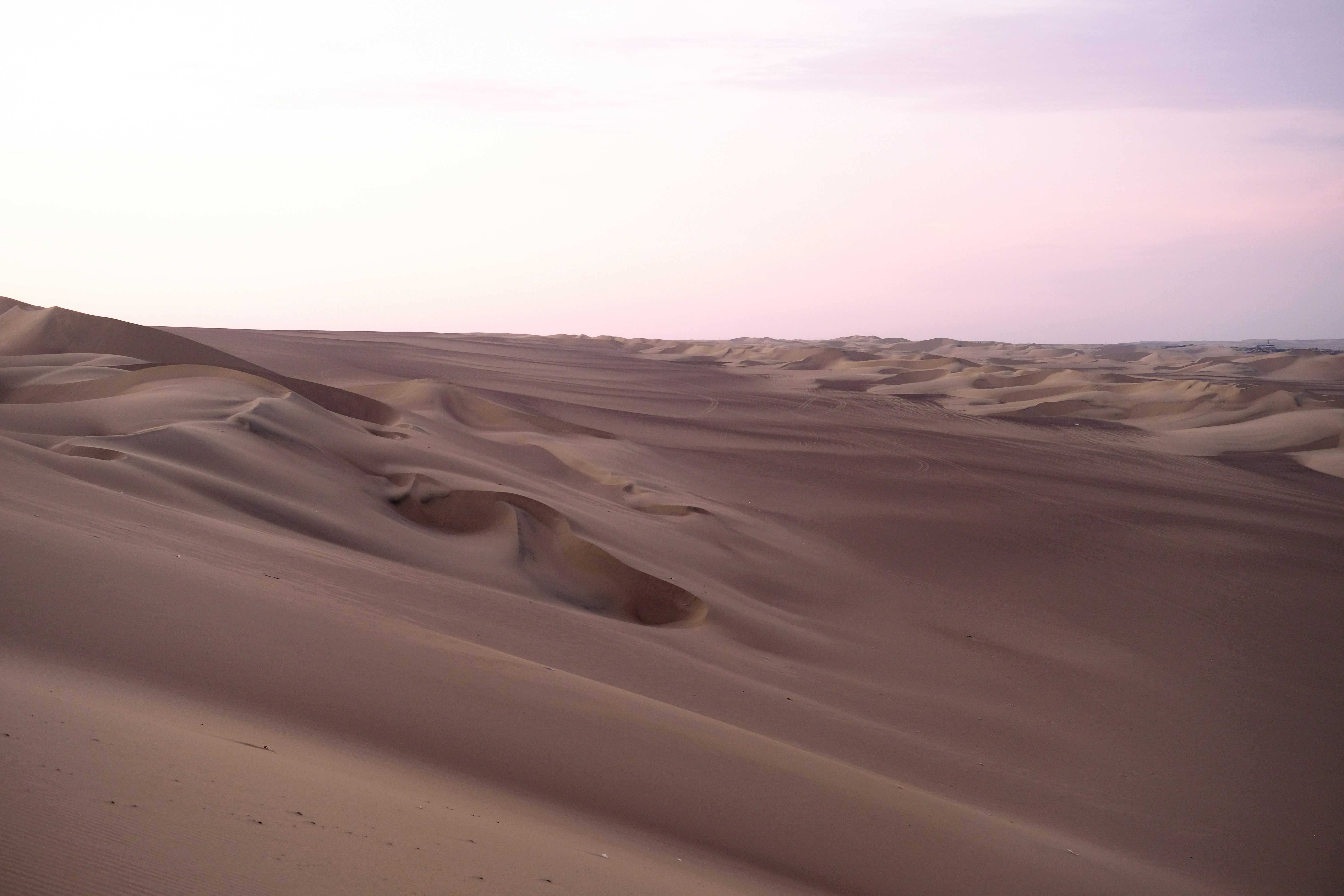 A person riding a bike on top of a sandy beach