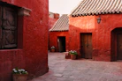 A red building with a potted plant in front of it