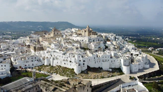 An aerial view of a city with white buildings