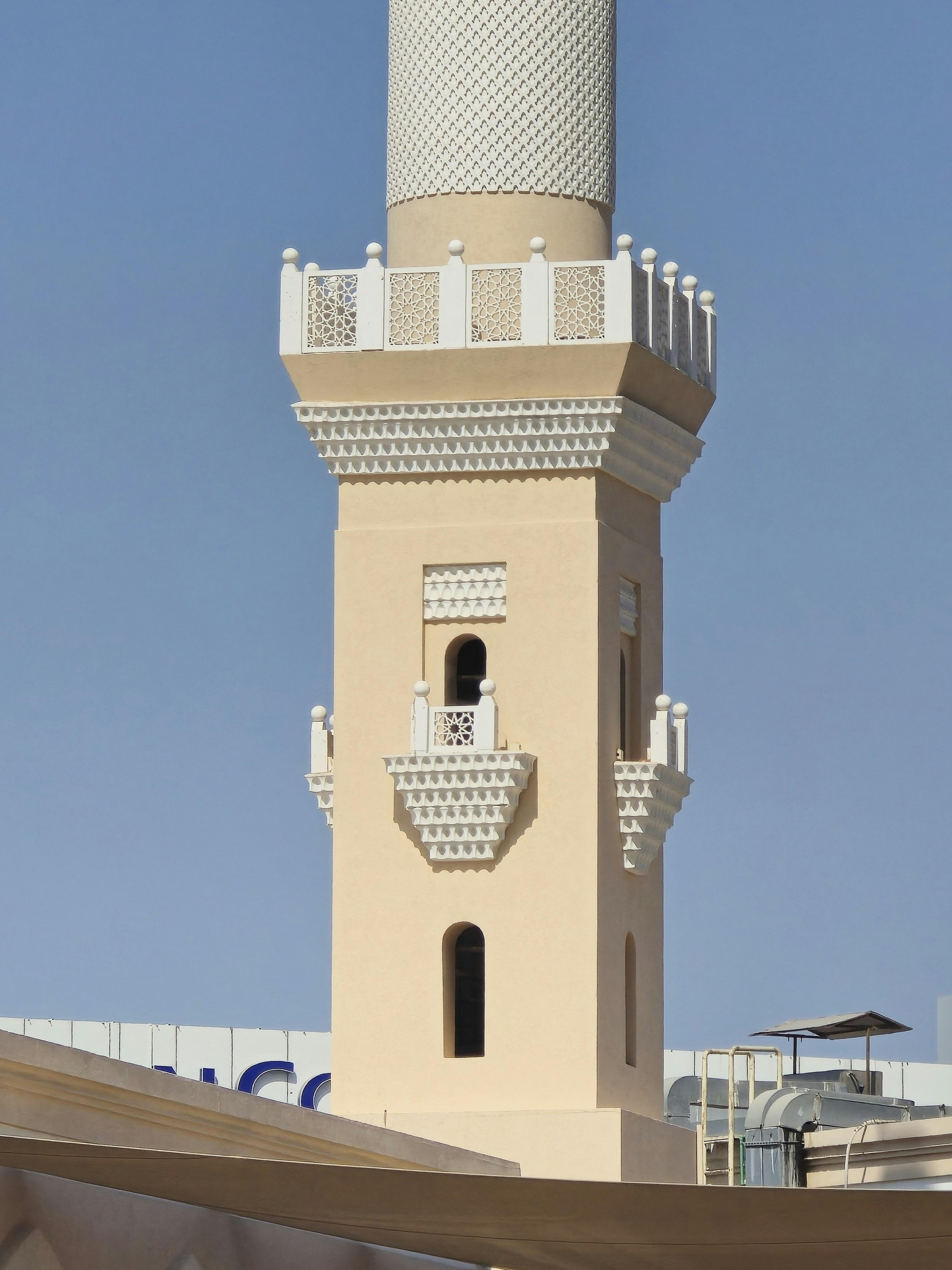 A tall white tower with a clock on it's side