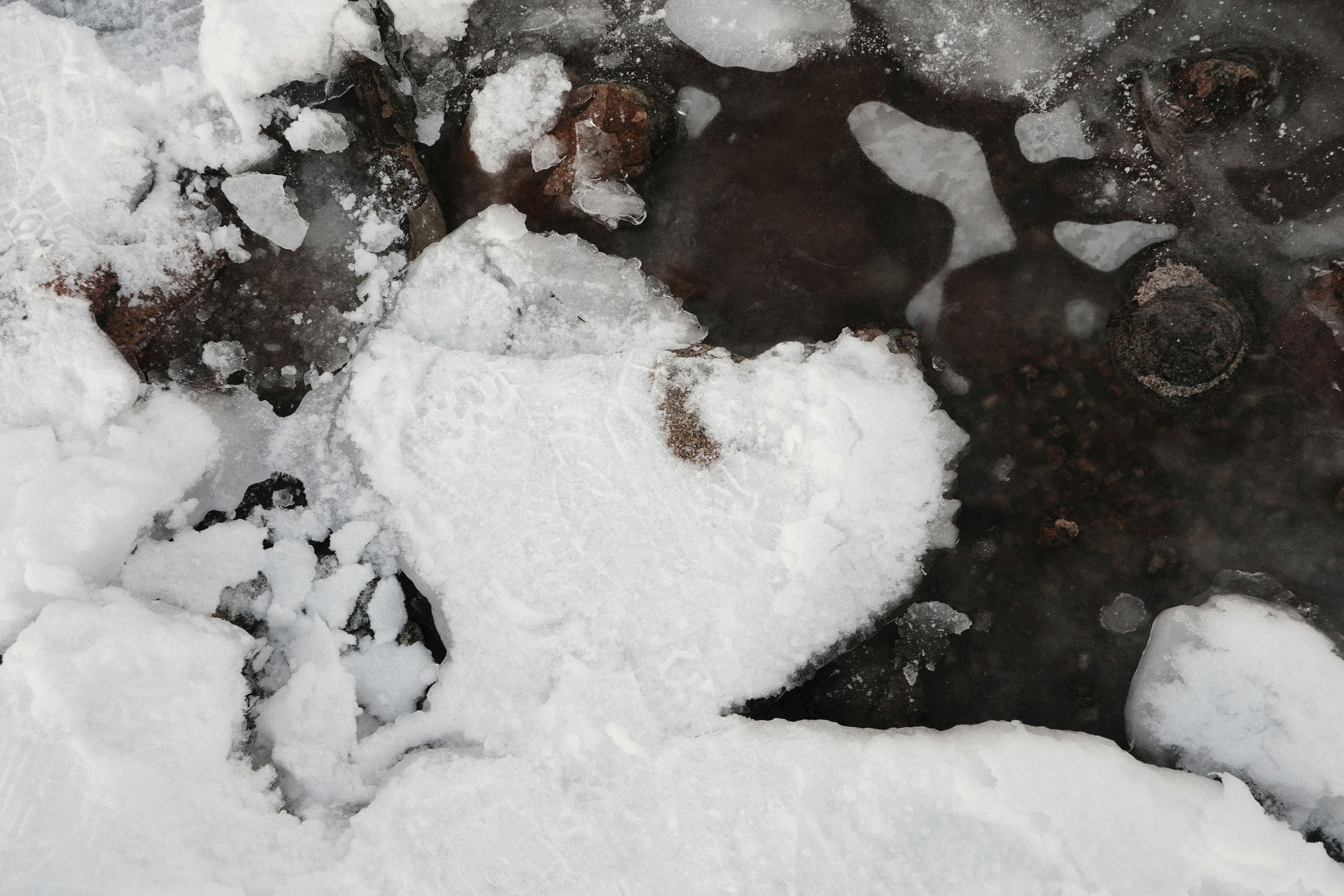 A black and white photo of snow and ice