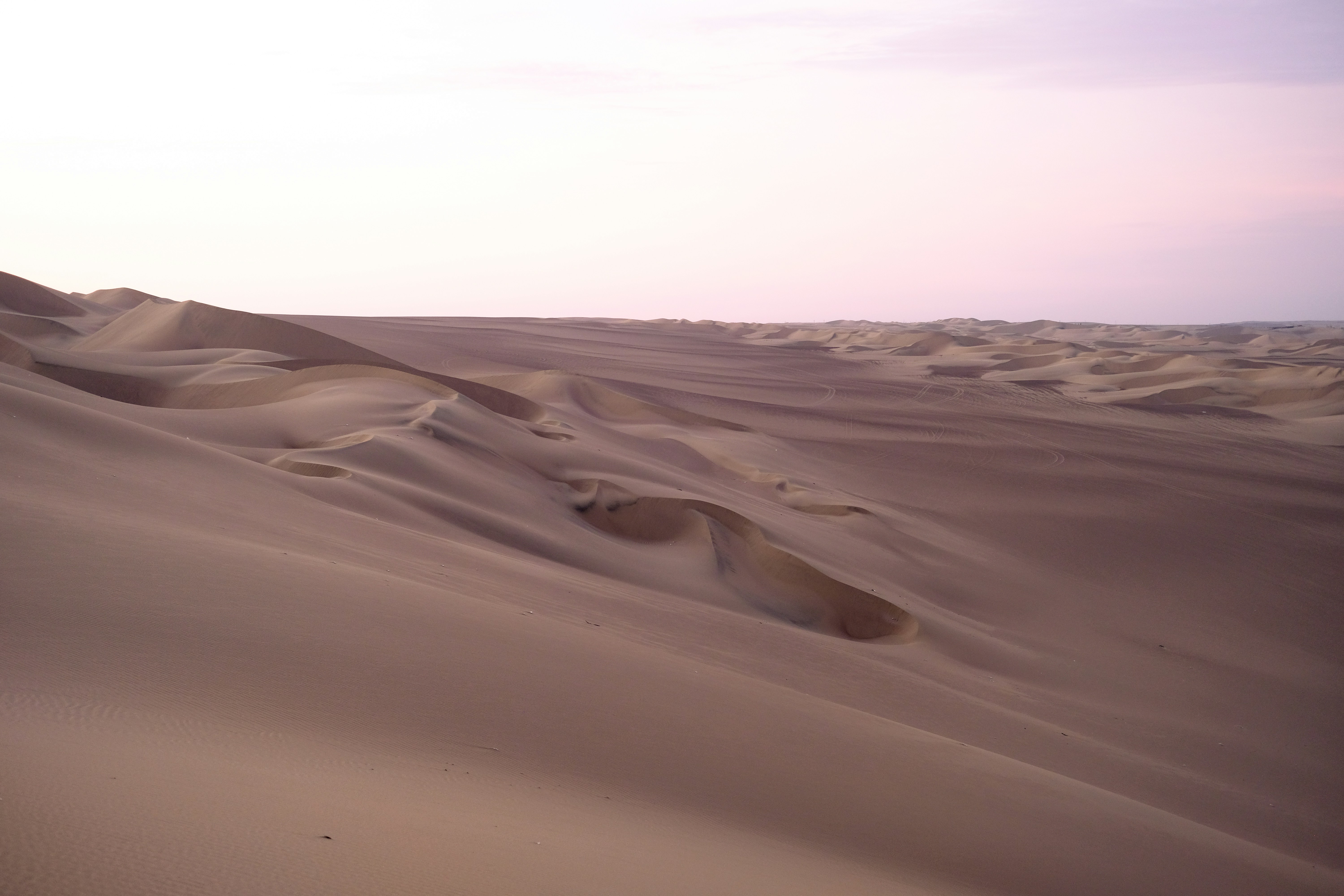 A blurry photo of a desert with sand dunes