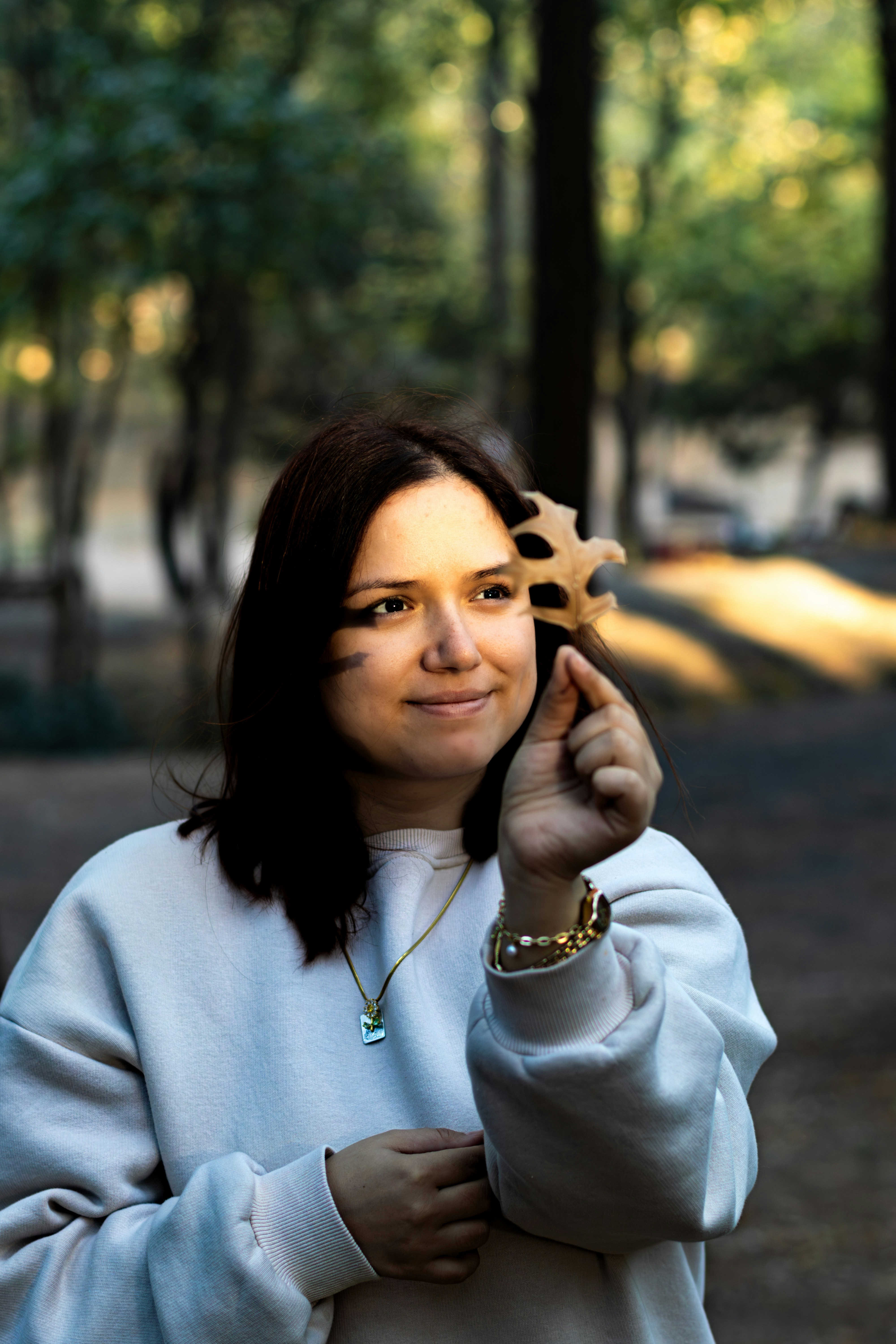 A woman holding a piece of wood in her hand