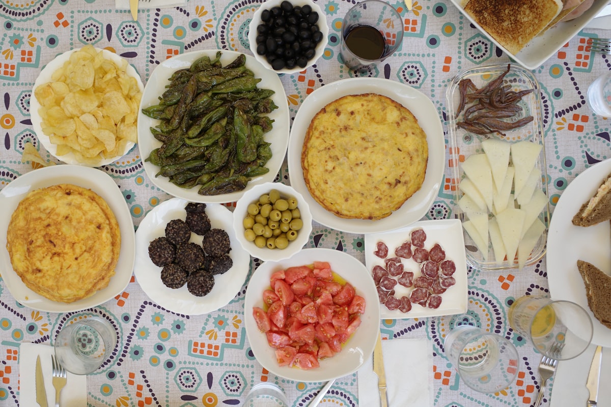 Long table laden with many different Mediterranean dishes, family-style spread