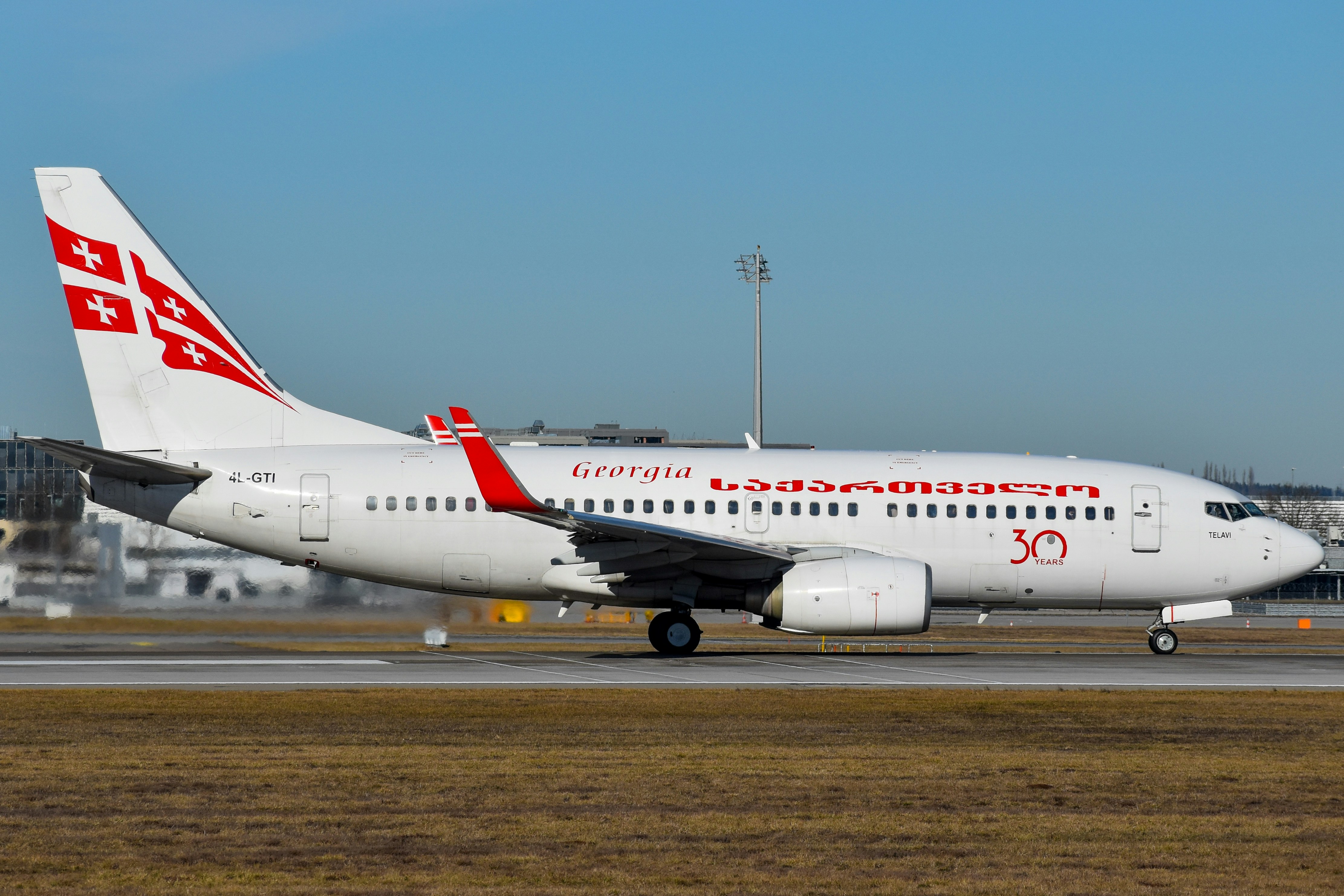 A large passenger jet sitting on top of an airport runway