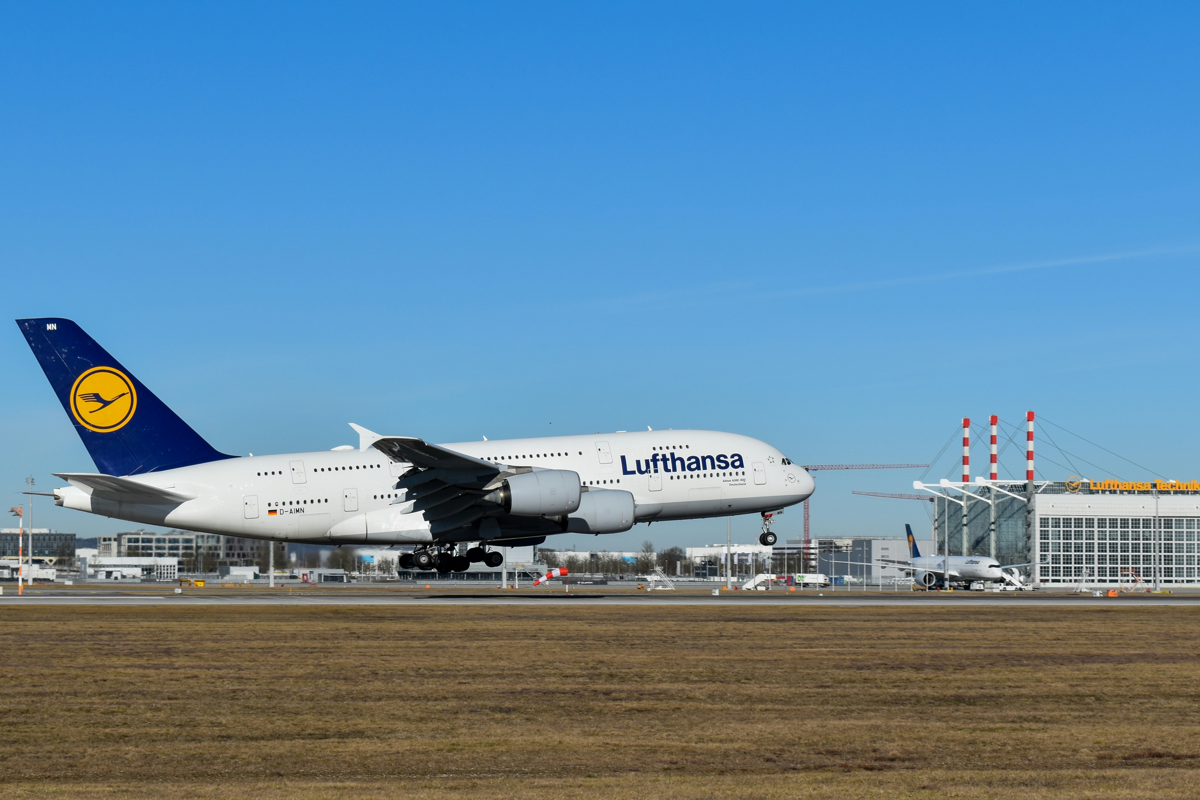A large jetliner sitting on top of an airport runway, Lufthansa A380 arriving in Munich
