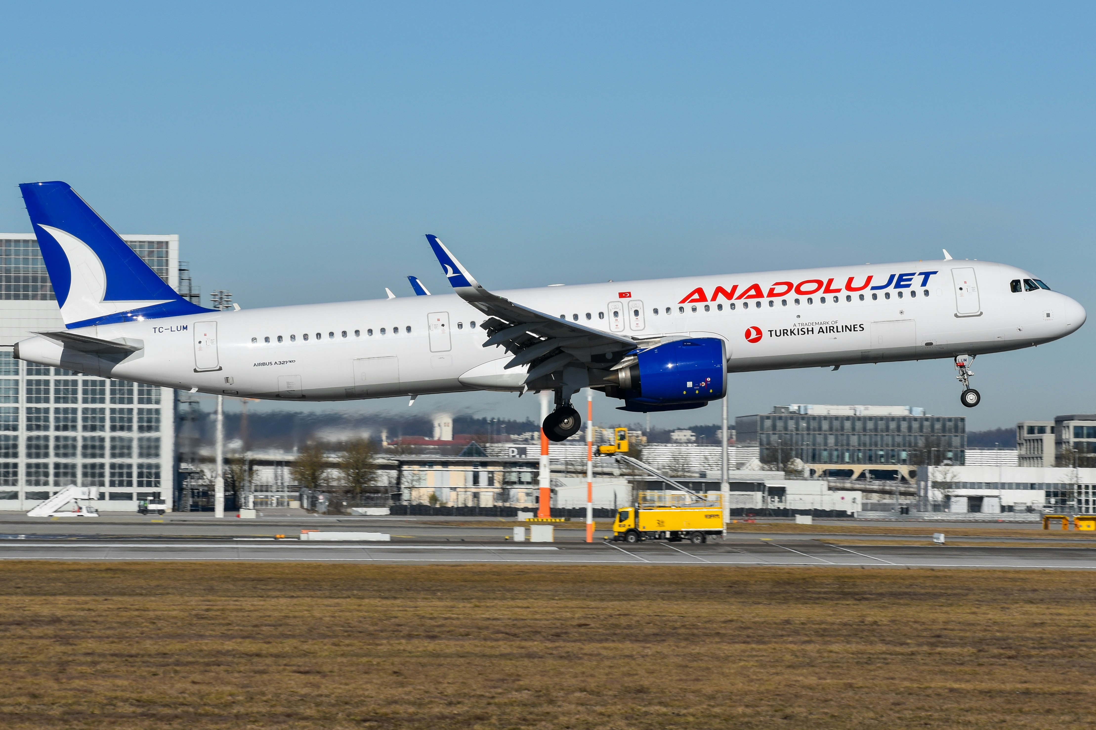 A large jetliner taking off from an airport runway, AnadoluJet A321neo arriving in Munich