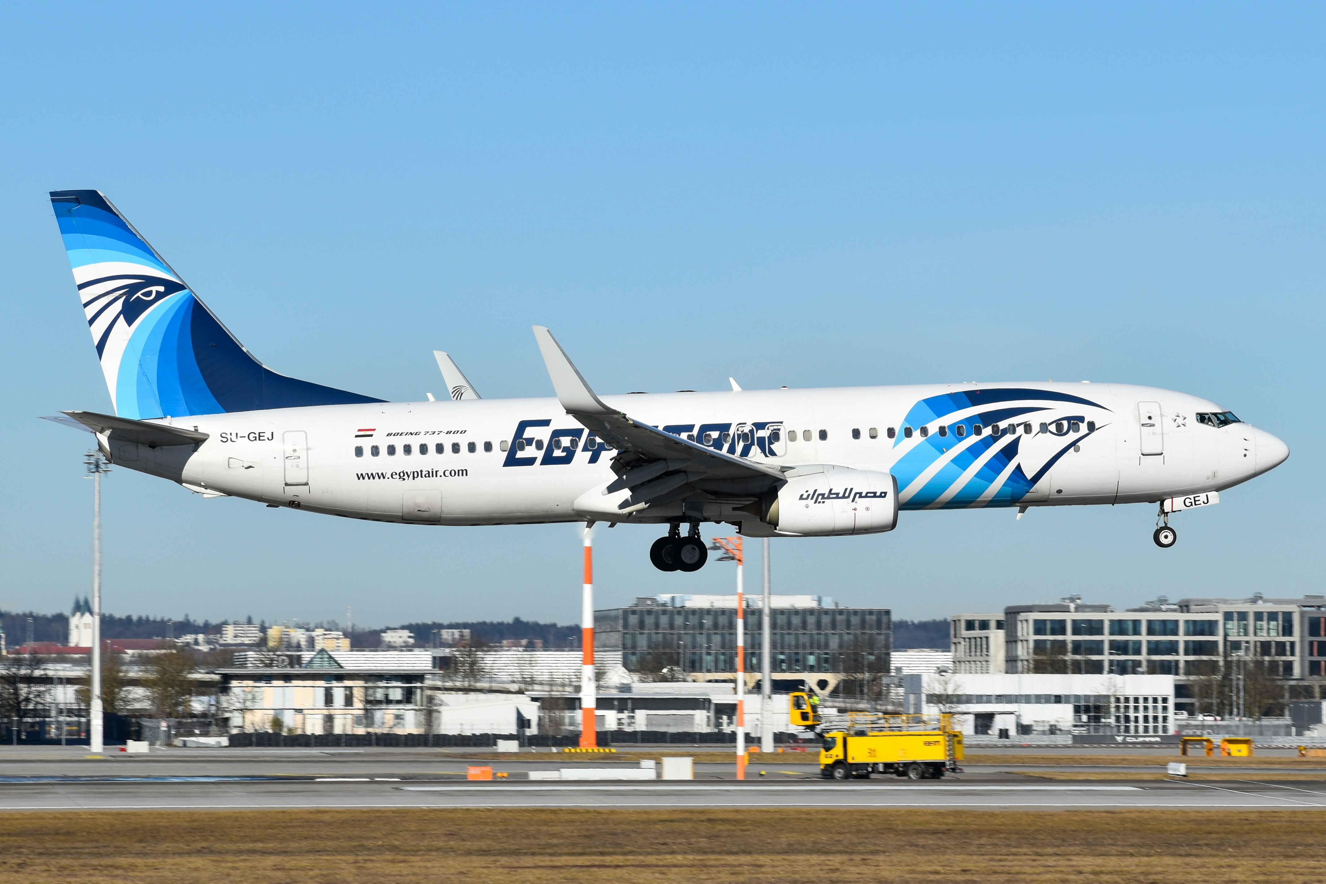 A large jetliner flying through a blue sky, EgyptAir 737 arriving in Munich