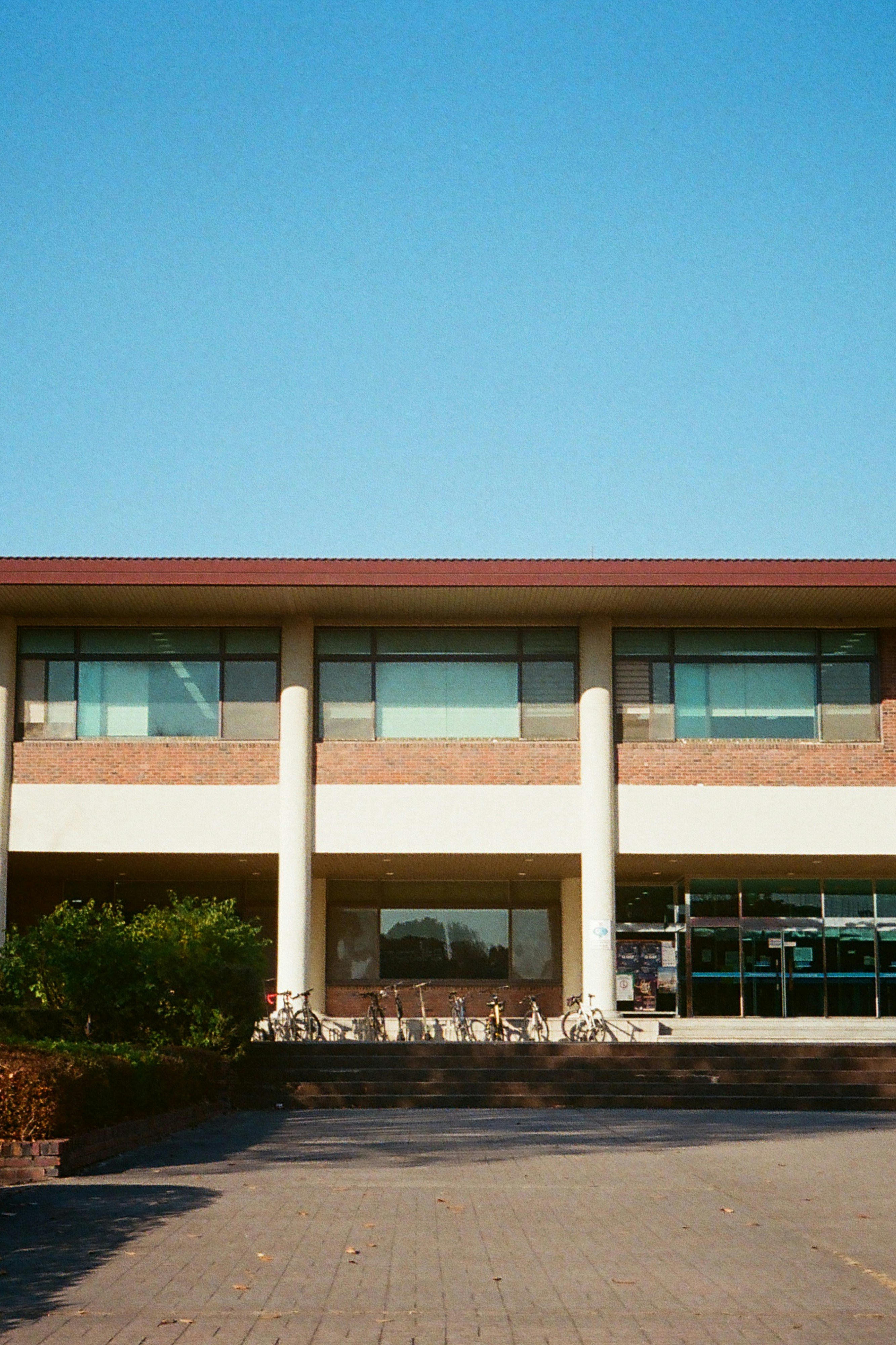 A large building with a parking lot in front of it