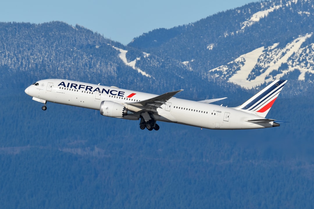 An airfrance airplane flying over a mountain range, Air France 787 departing Vancouver