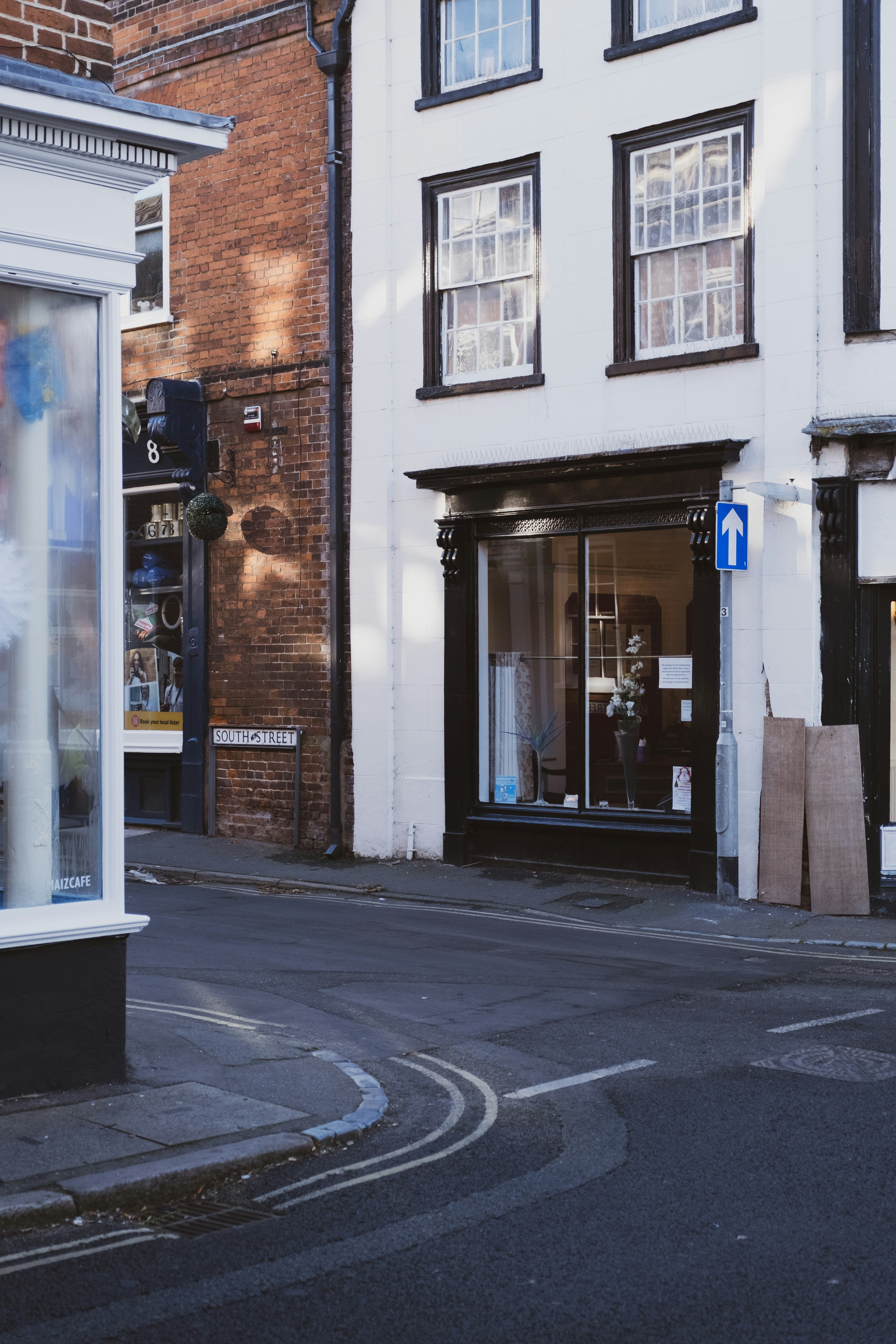 A street corner with a store front on the corner