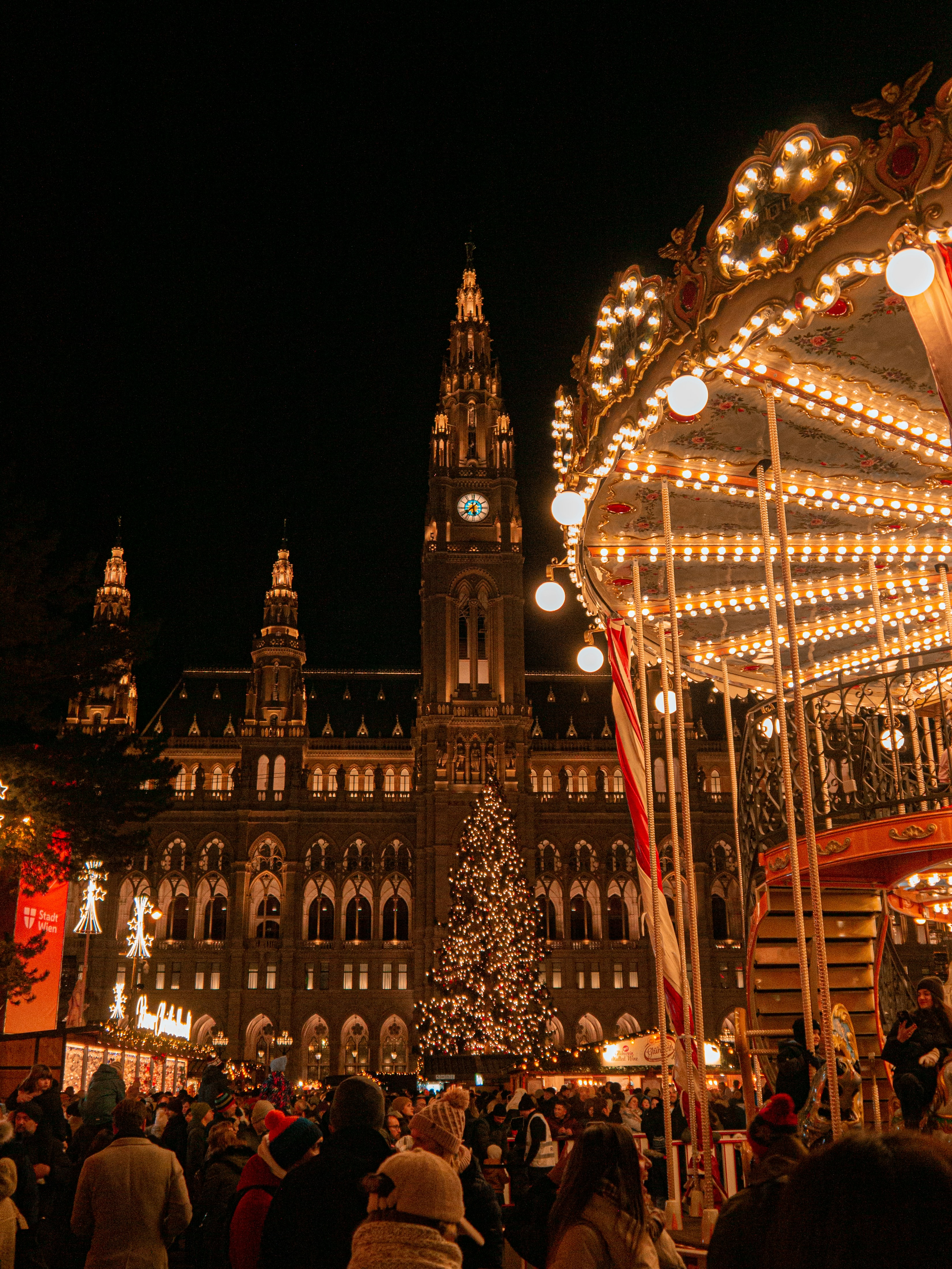 A merry go round in front of a large building