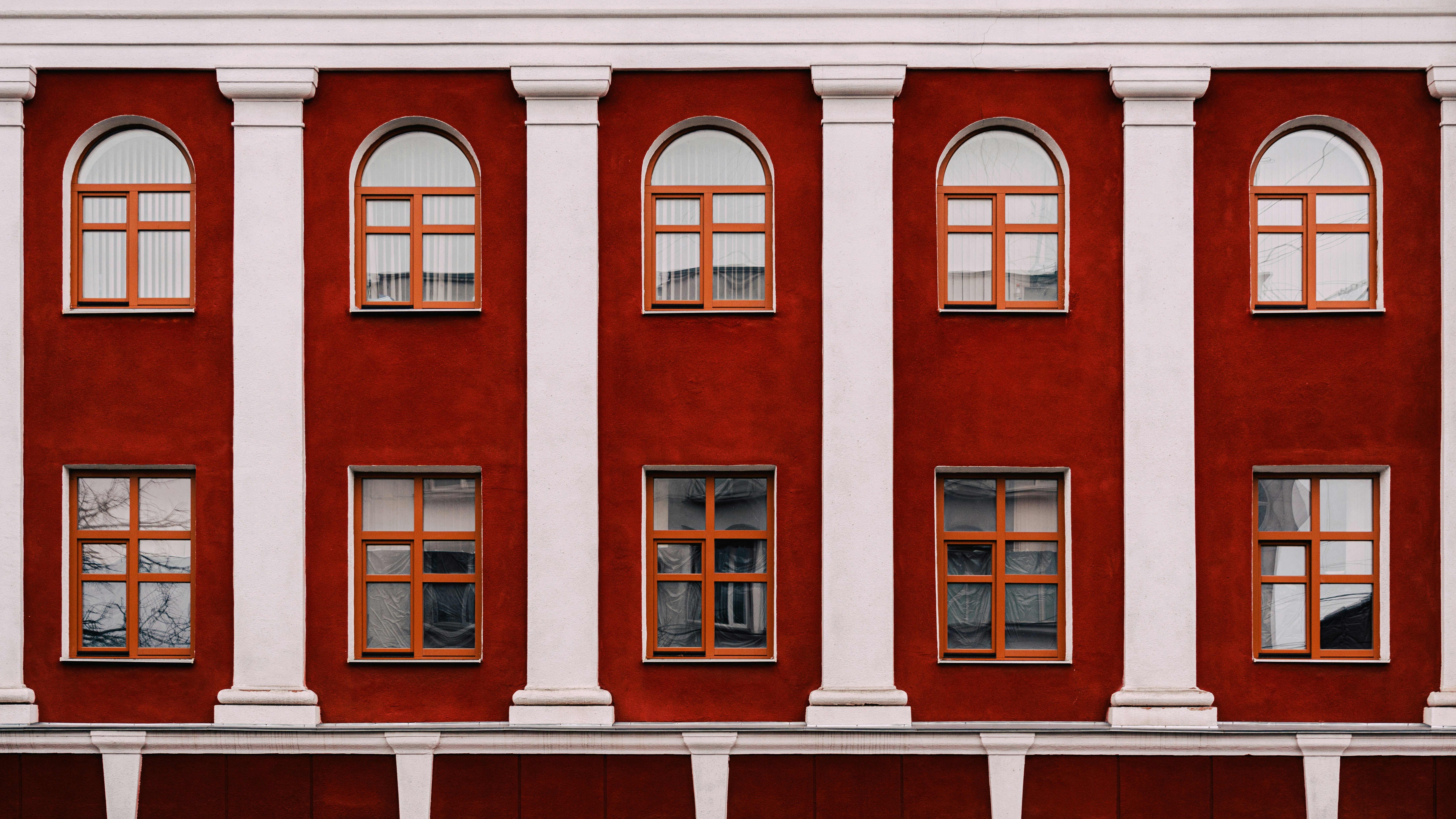 A red and white building with multiple windows photo – Free Building ...