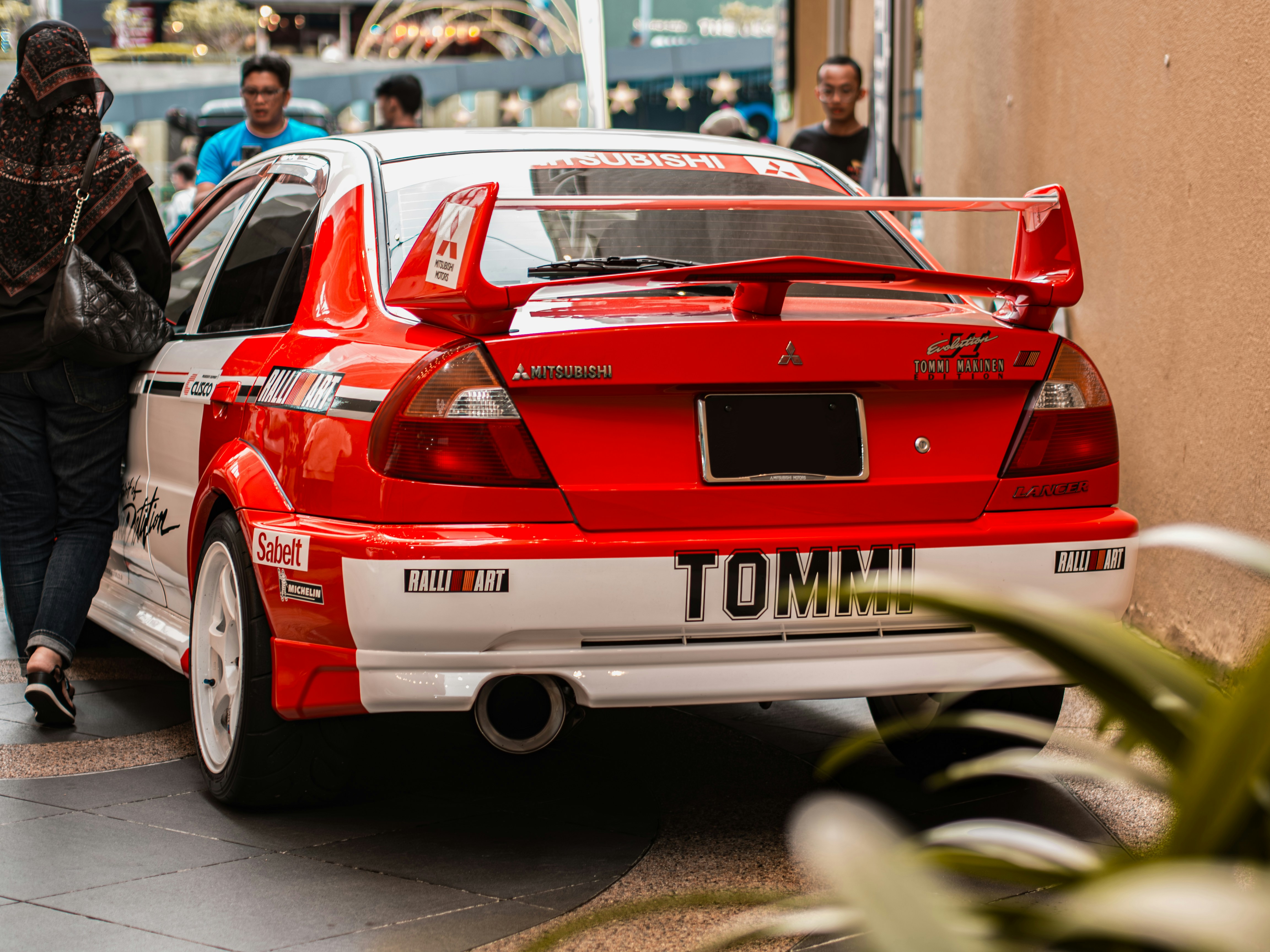 A red car parked on the side of the road