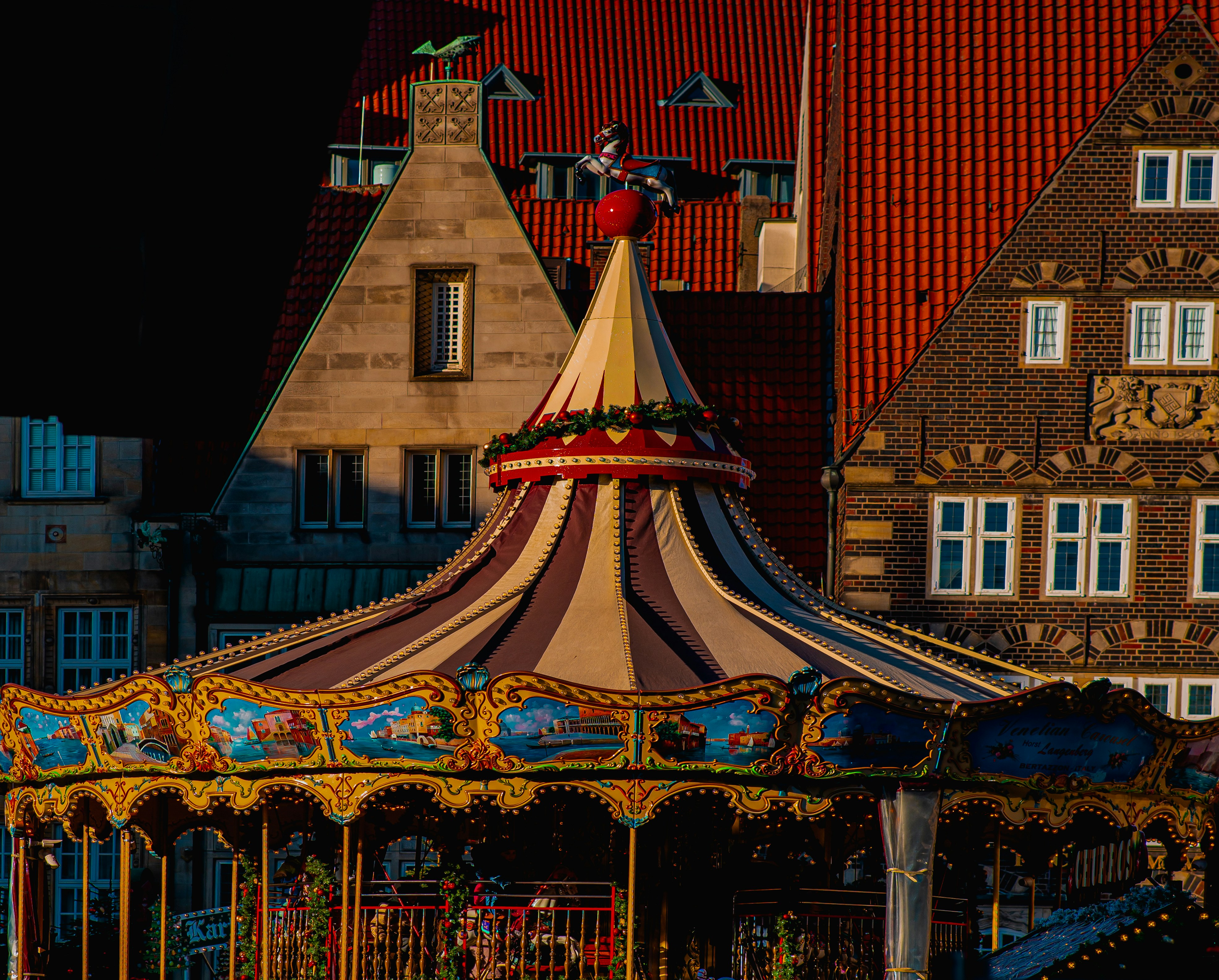 A merry go round in front of some buildings photo – Free Bremen Image ...