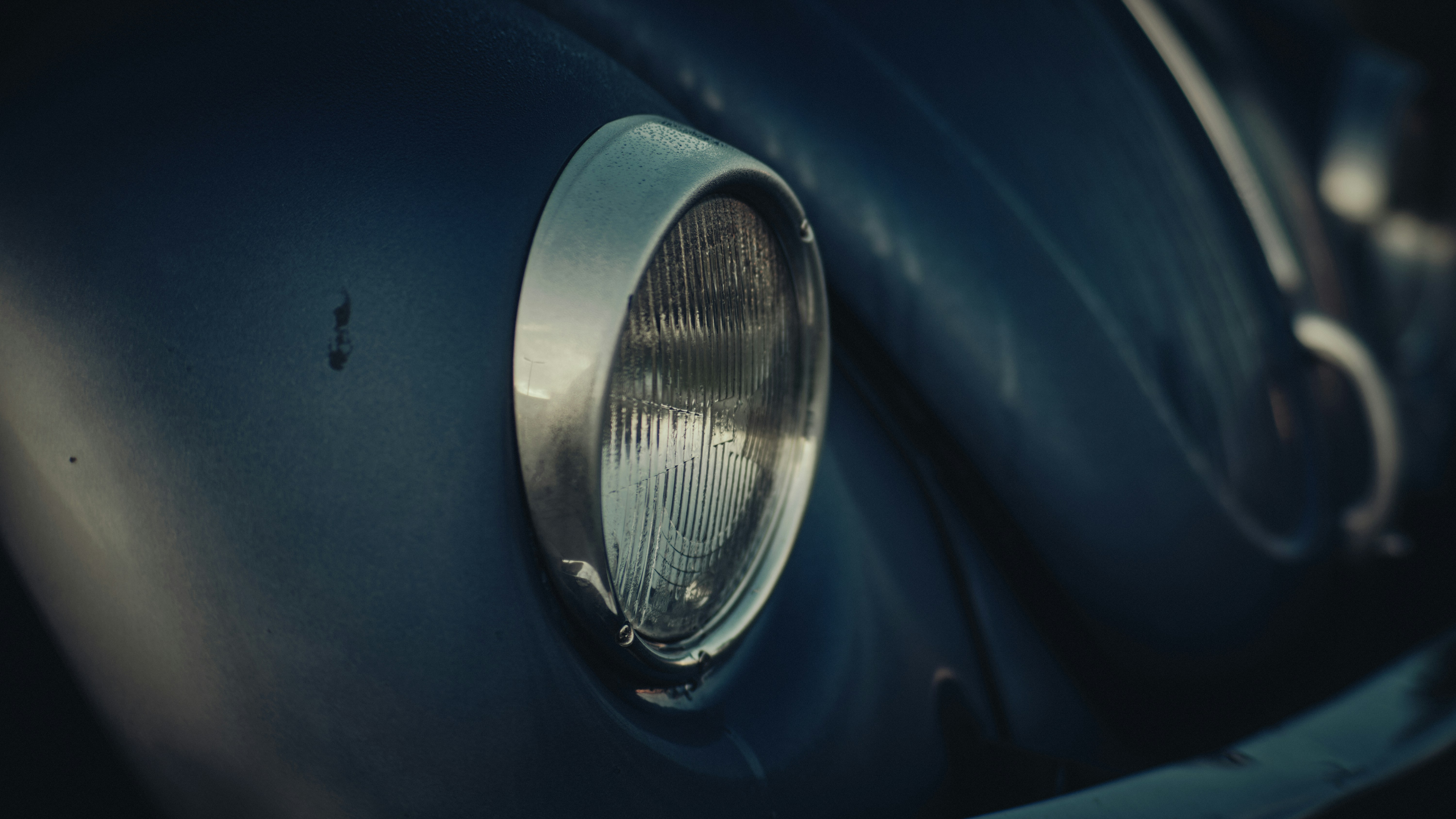 A close up of the front end of a classic car