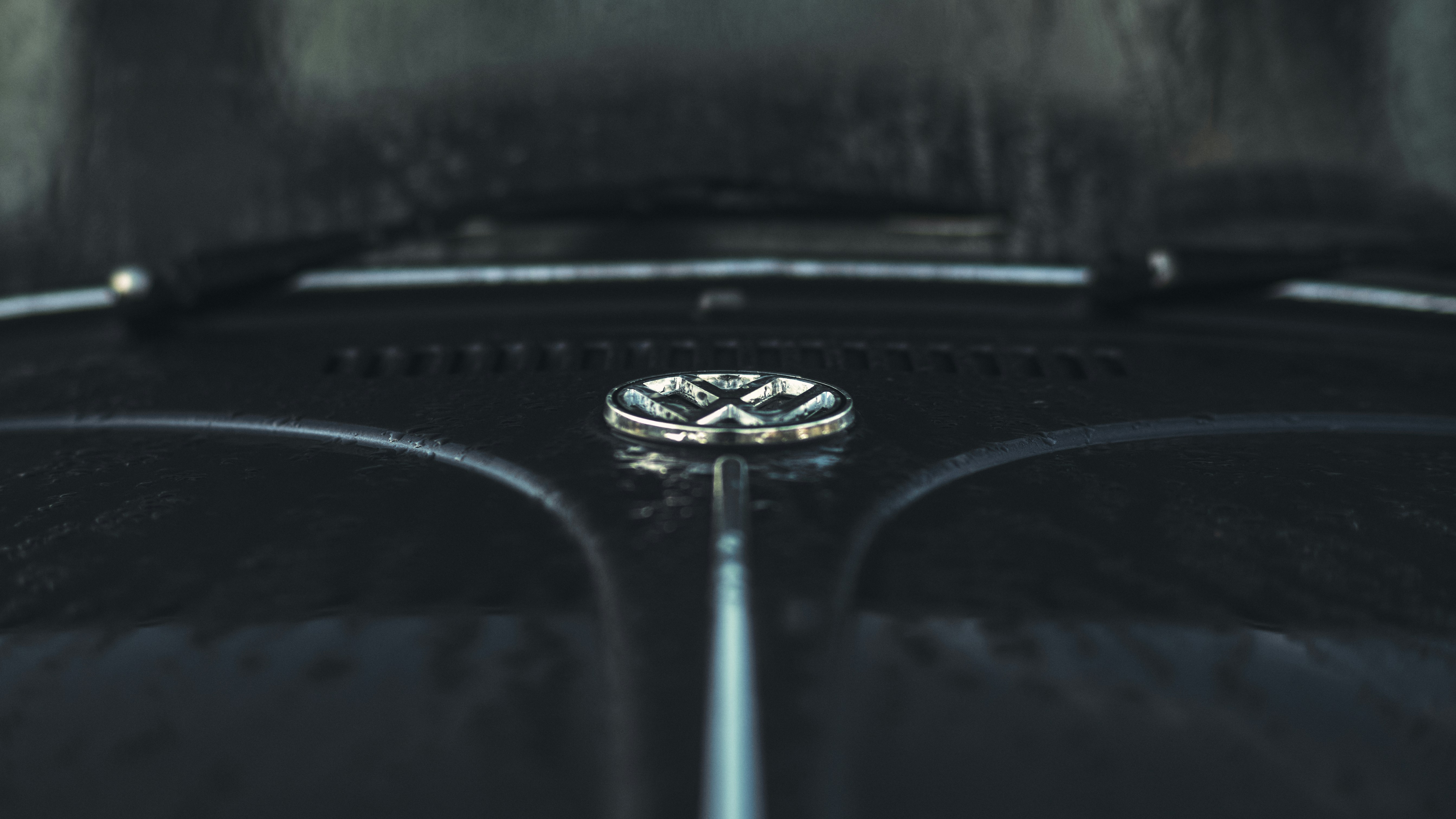 A close up of a black car with a diamond ring on the hood