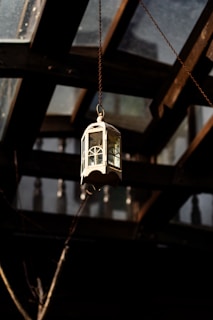 A lantern hanging from the ceiling of a building
