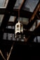 A lantern hanging from the ceiling of a building