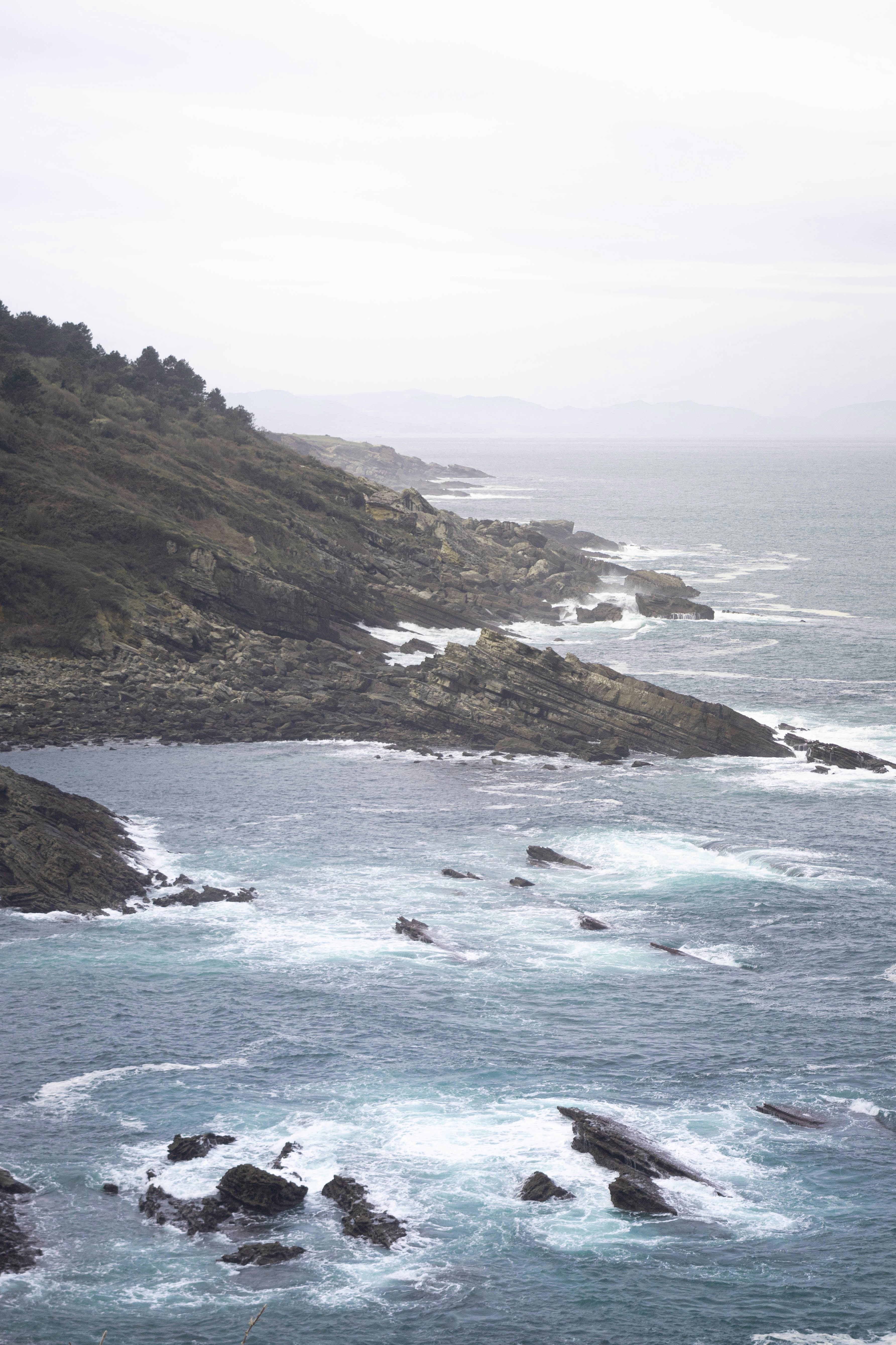 A large body of water near a rocky shore