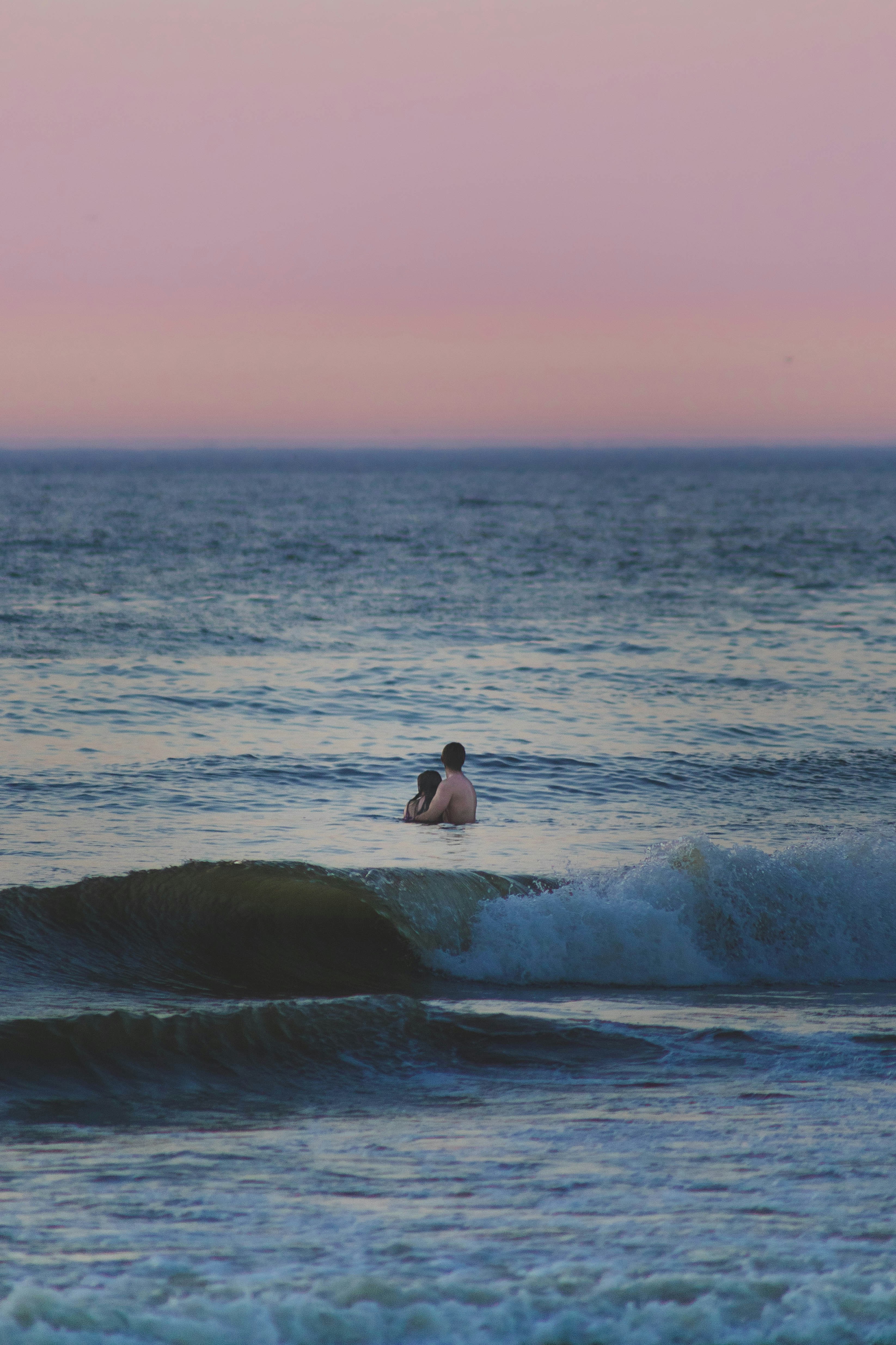 A man riding a wave on top of a surfboard