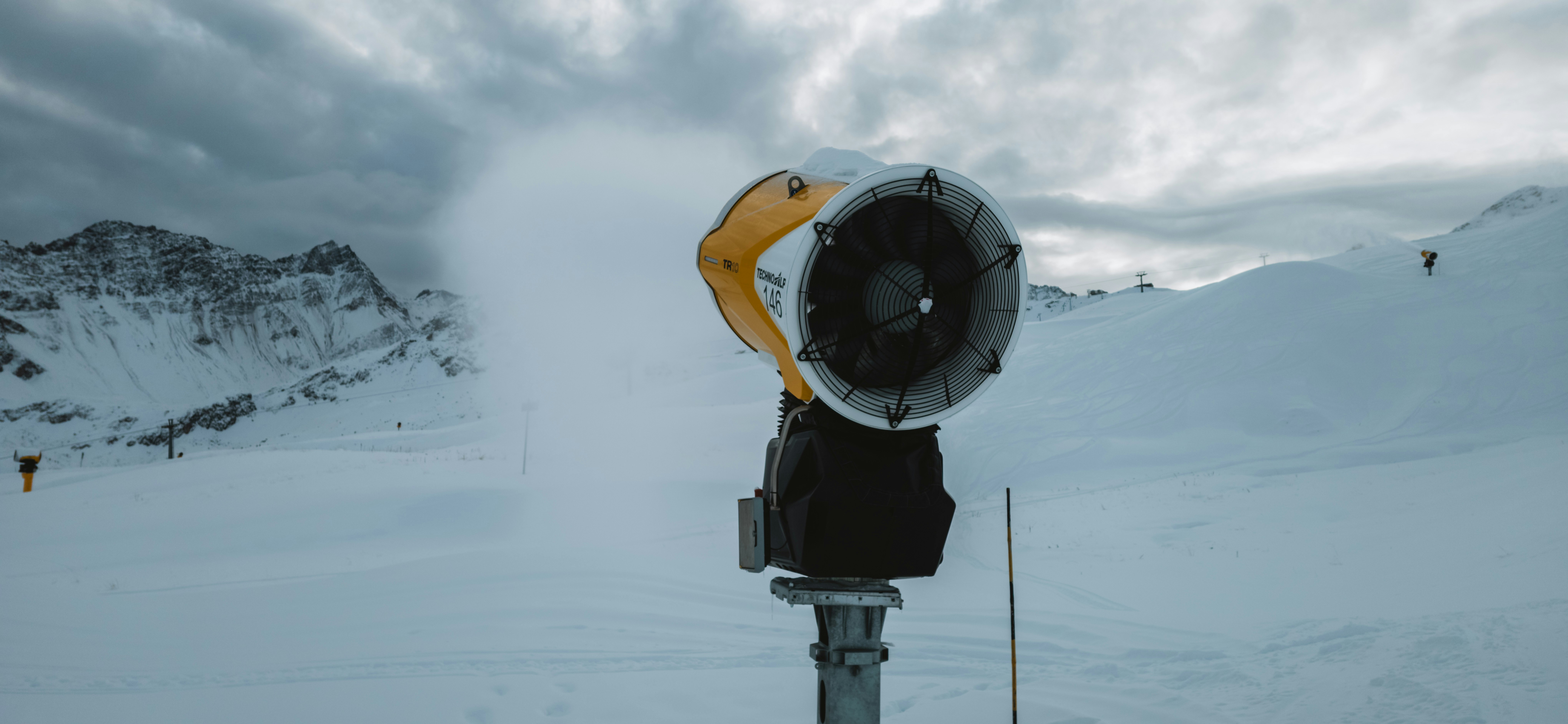 A parking meter in the middle of a snowy field