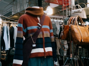 A mannequin wearing a multicolored sweater in a clothing store