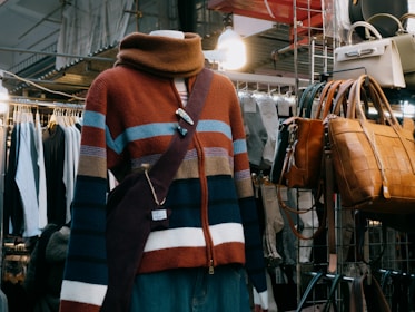 A mannequin wearing a multicolored sweater in a clothing store