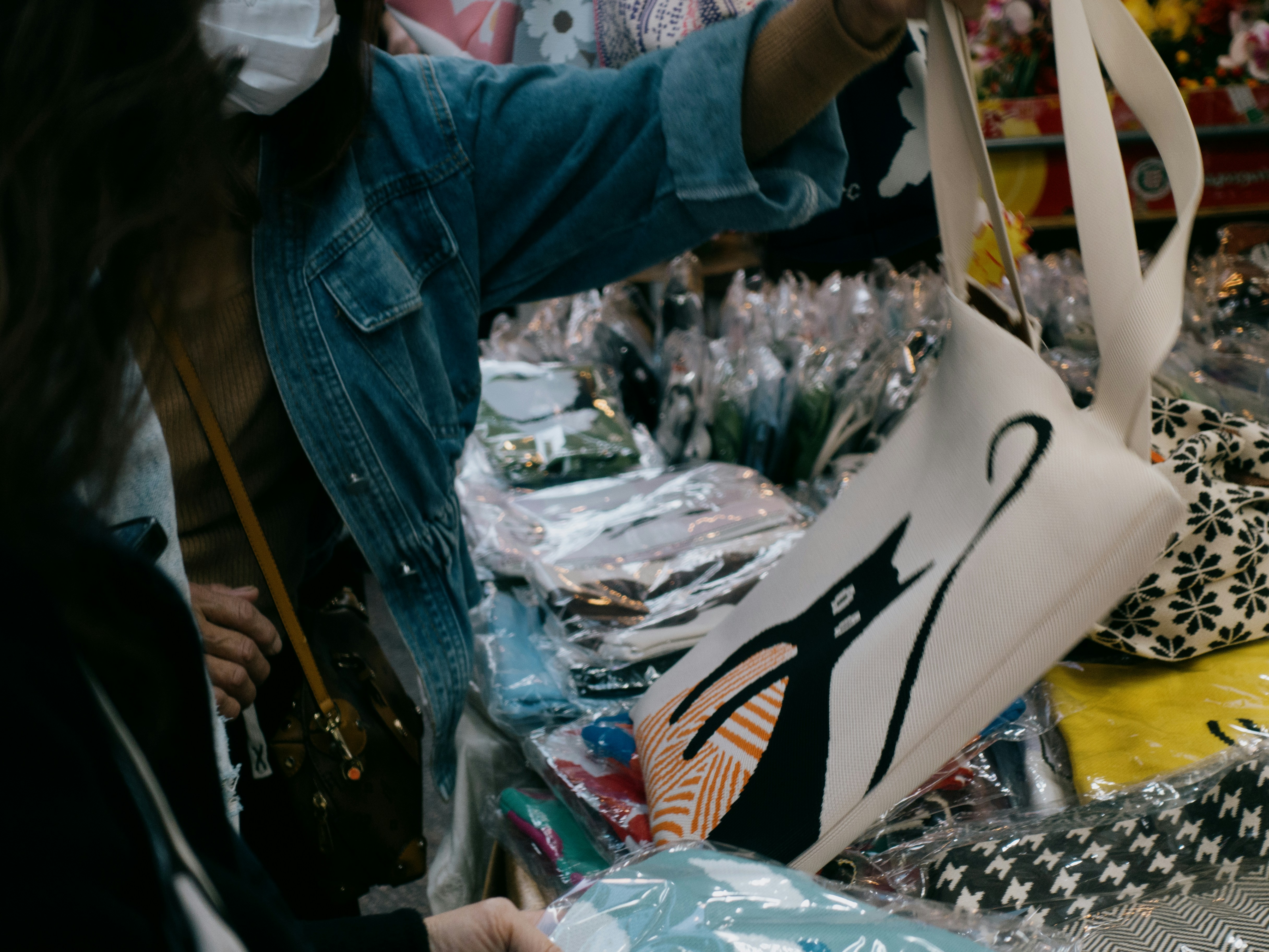 A woman looking at a bag in a
