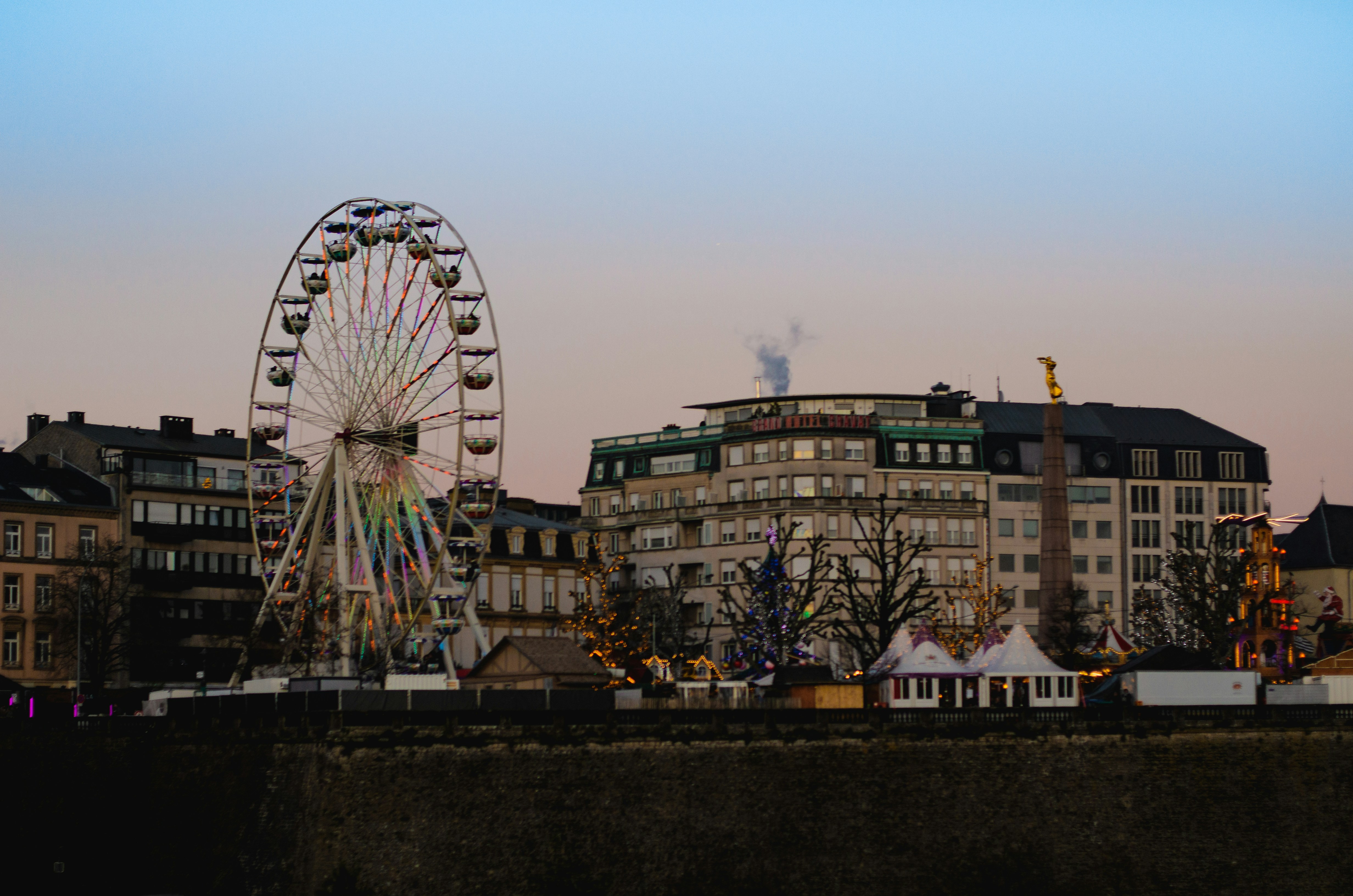 A large ferris wheel sitting next to a river