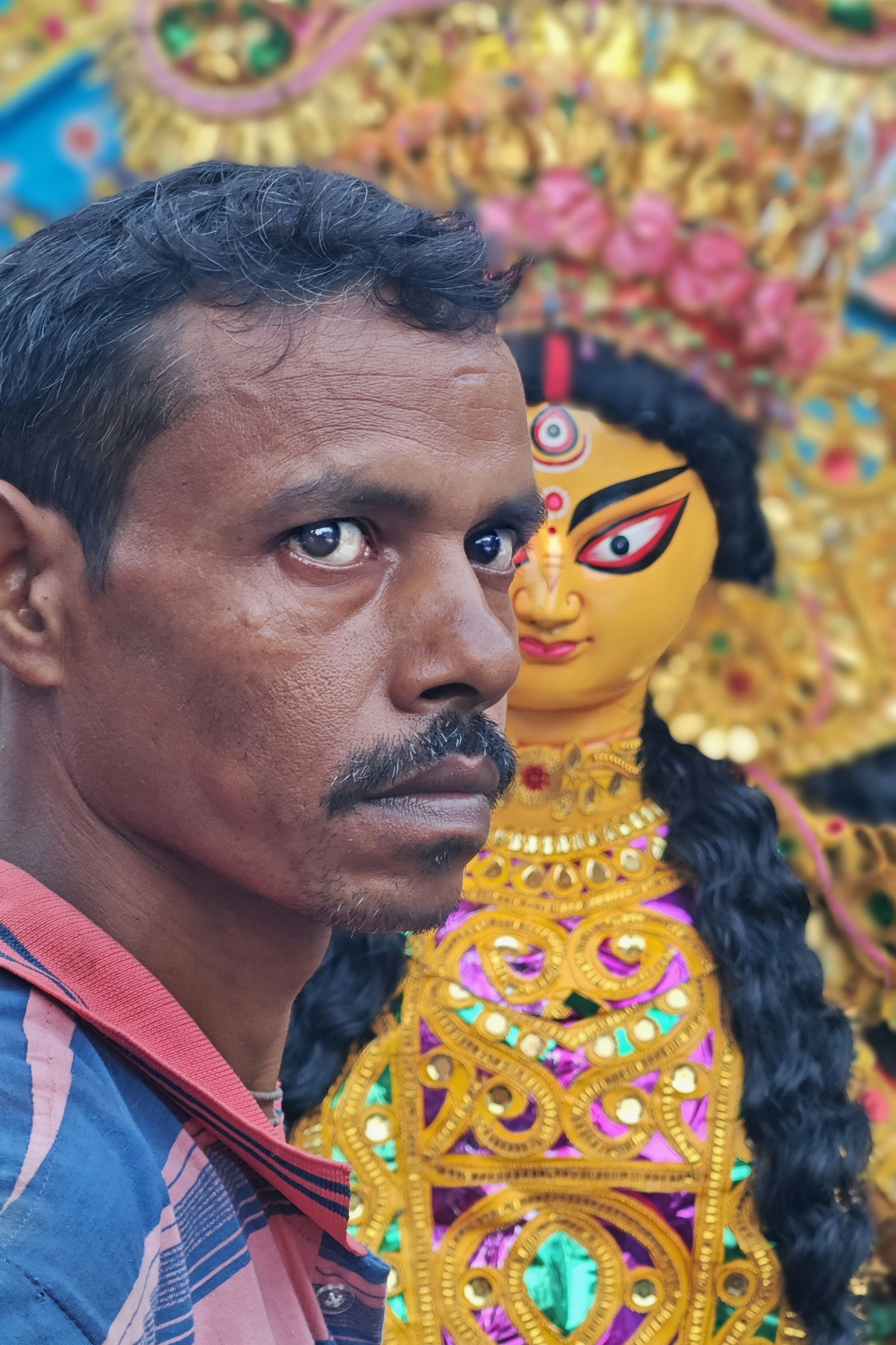 A man standing next to a statue of a woman