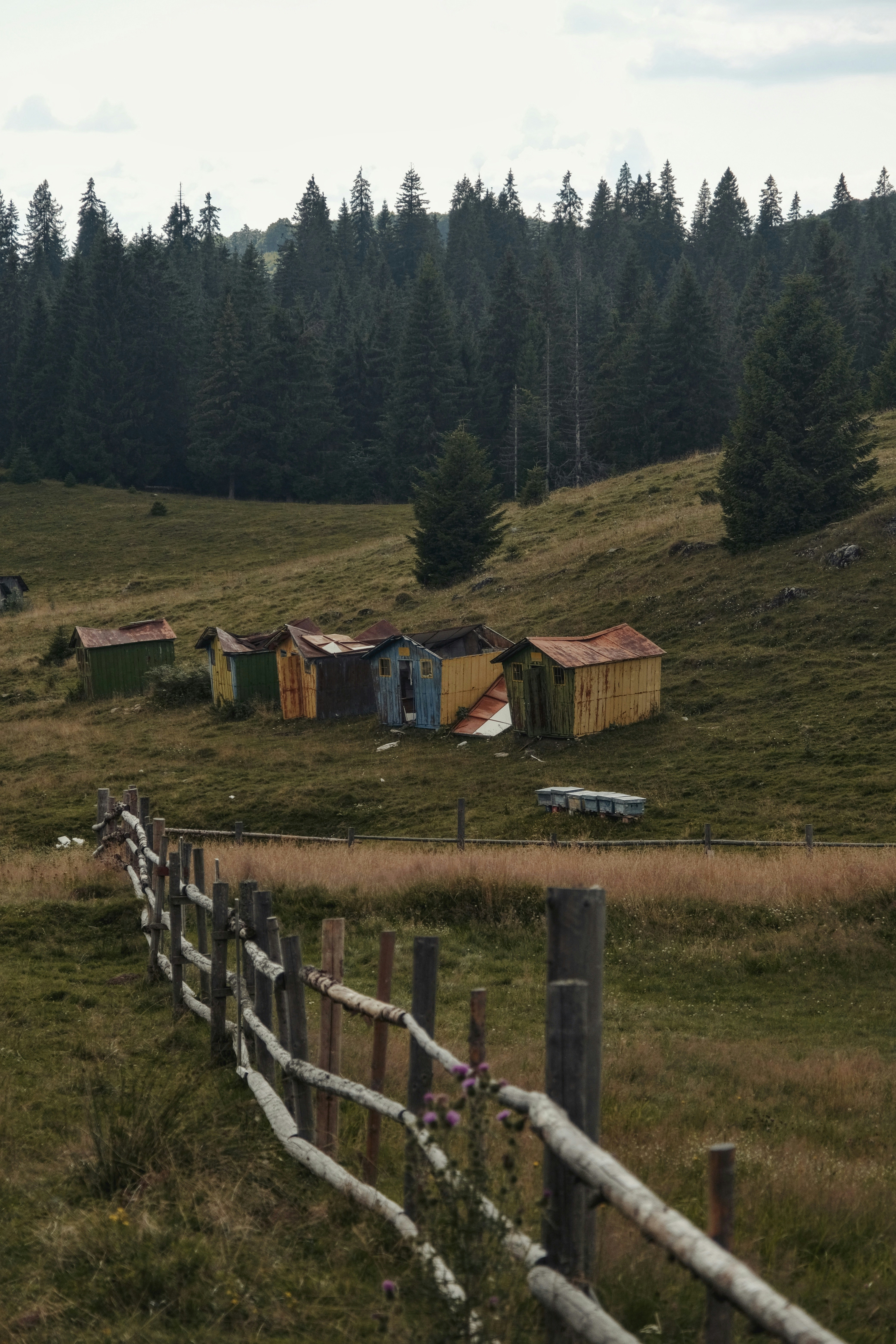 A fence in front of a grassy field