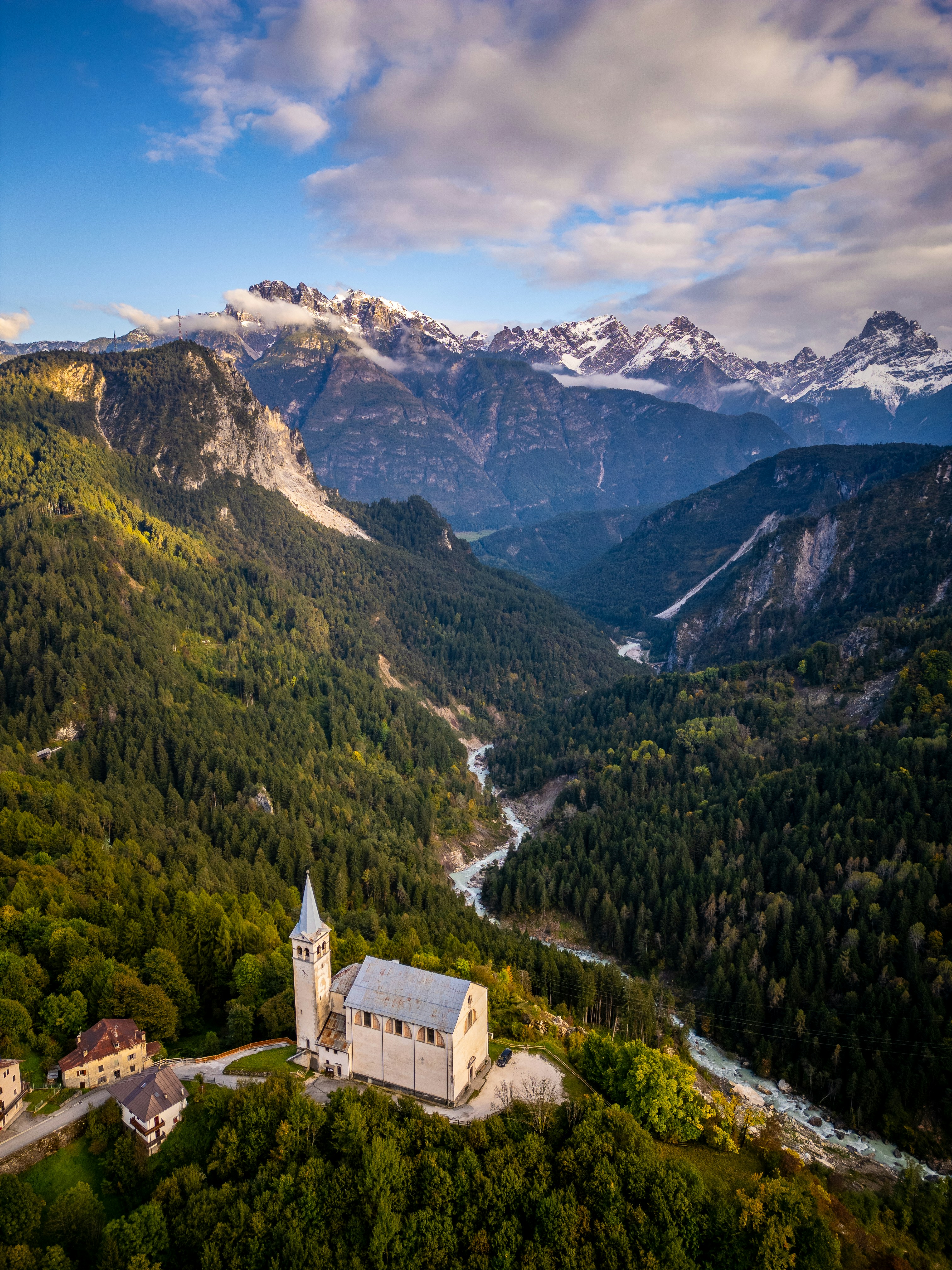 An aerial view of a church in the mountains