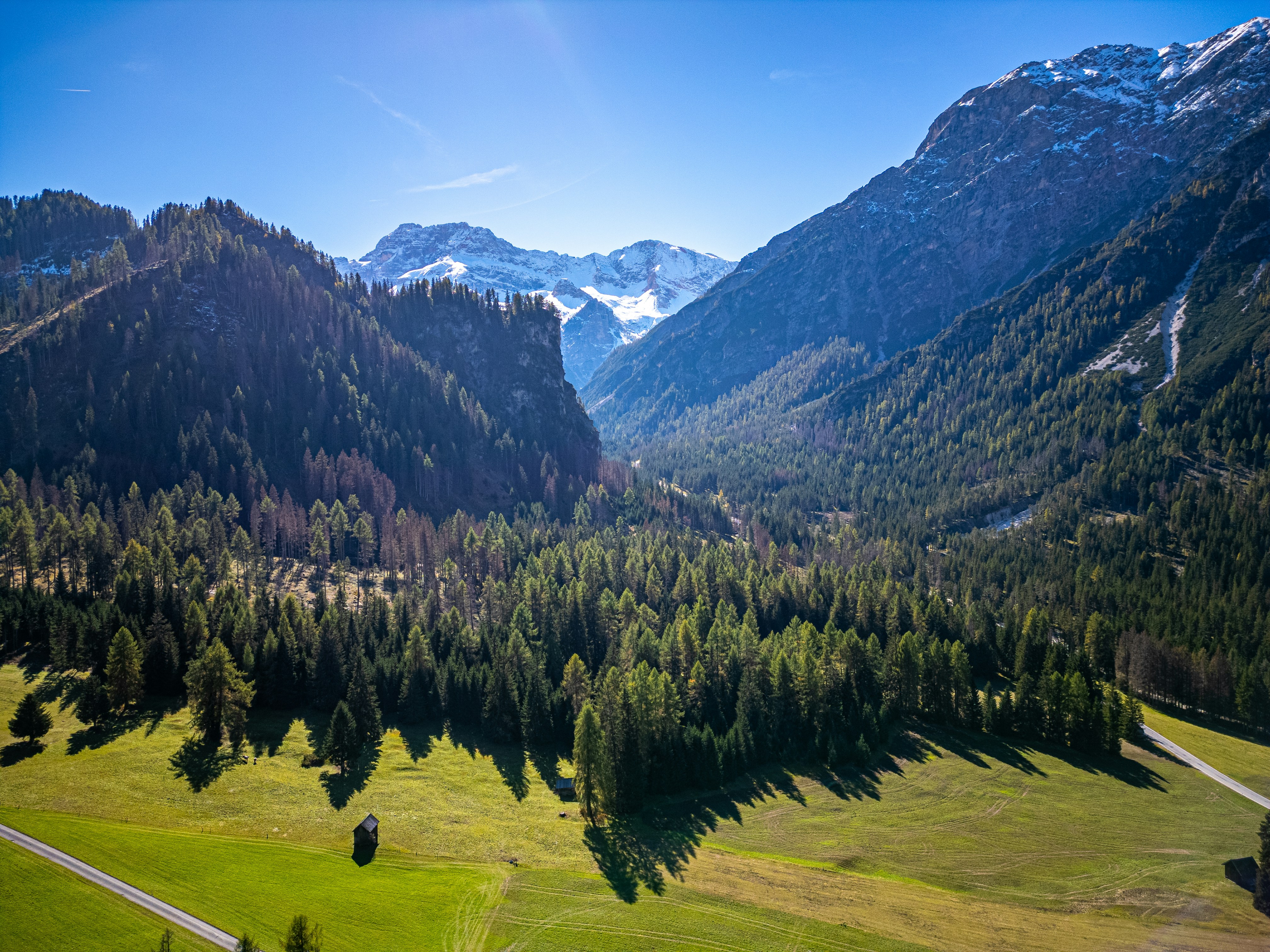 An aerial view of a valley with mountains in the background