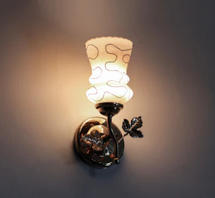 A wall light with a glass shade on it