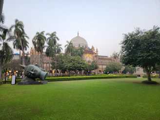 A statue of a bull in the middle of a park