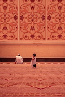 muslim parent and child sitting in masjid