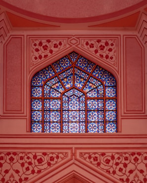 A window in a building with a blue sky in the background