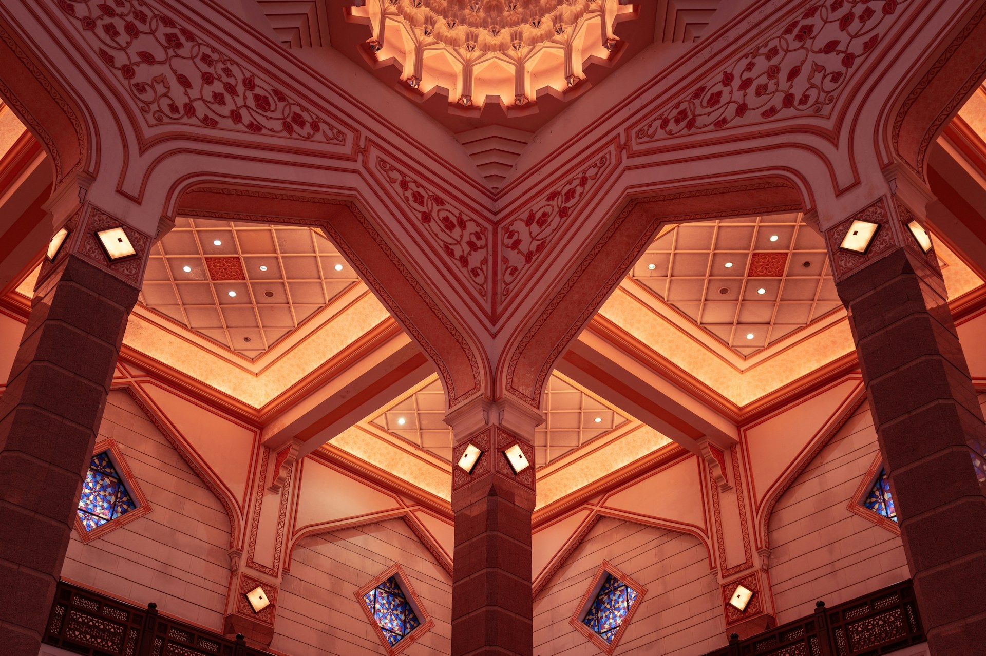 The ceiling of a large building with many windows