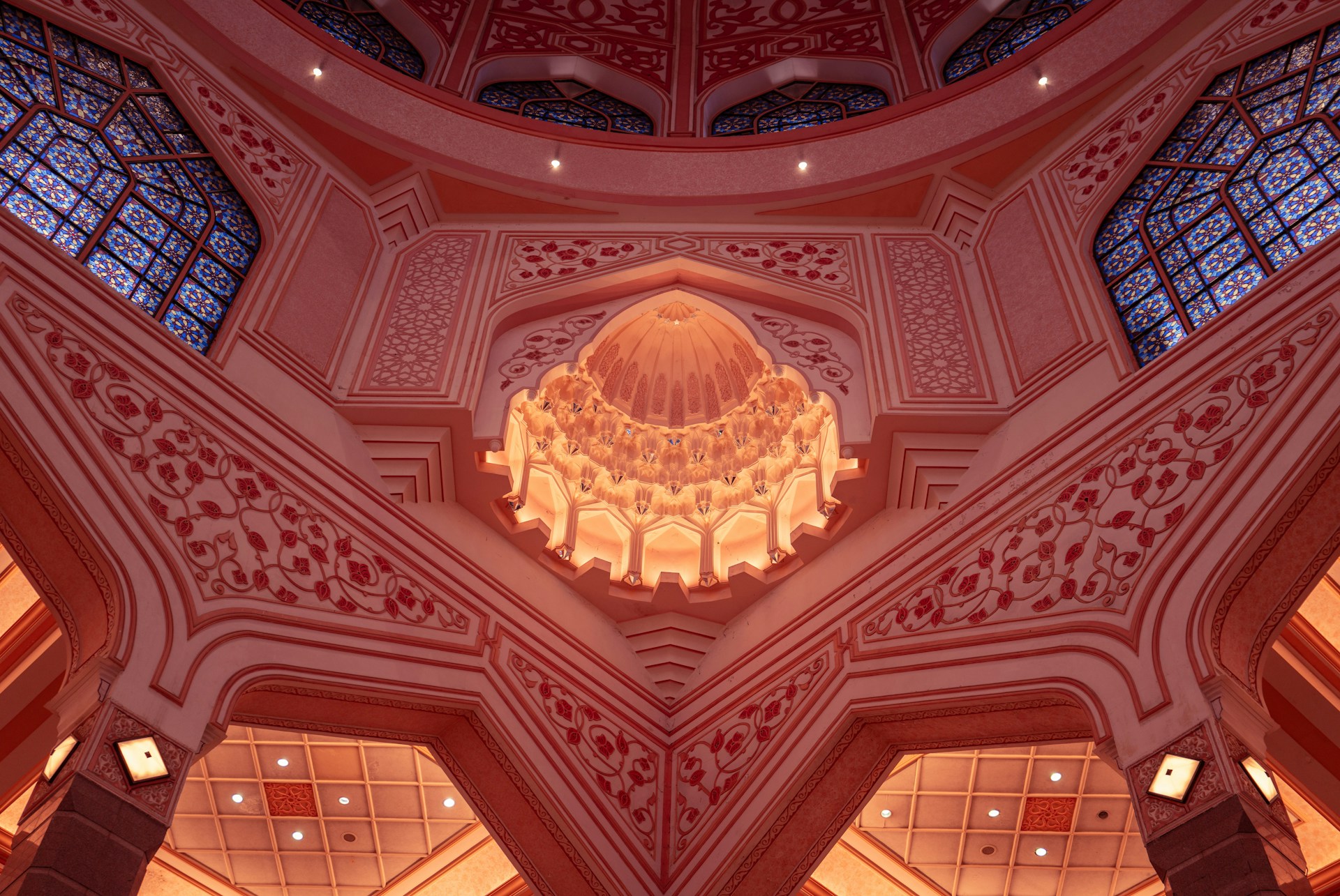 The ceiling of a large building with a chandelier