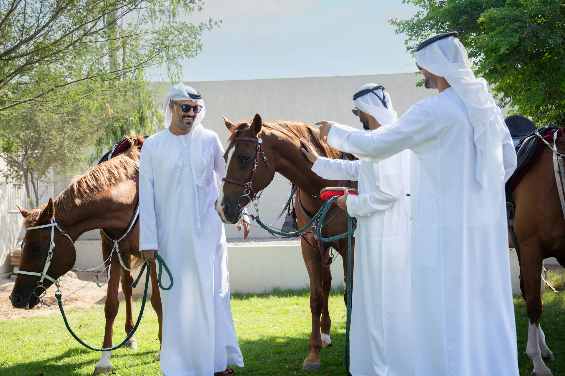 A group of men standing next to a brown horse