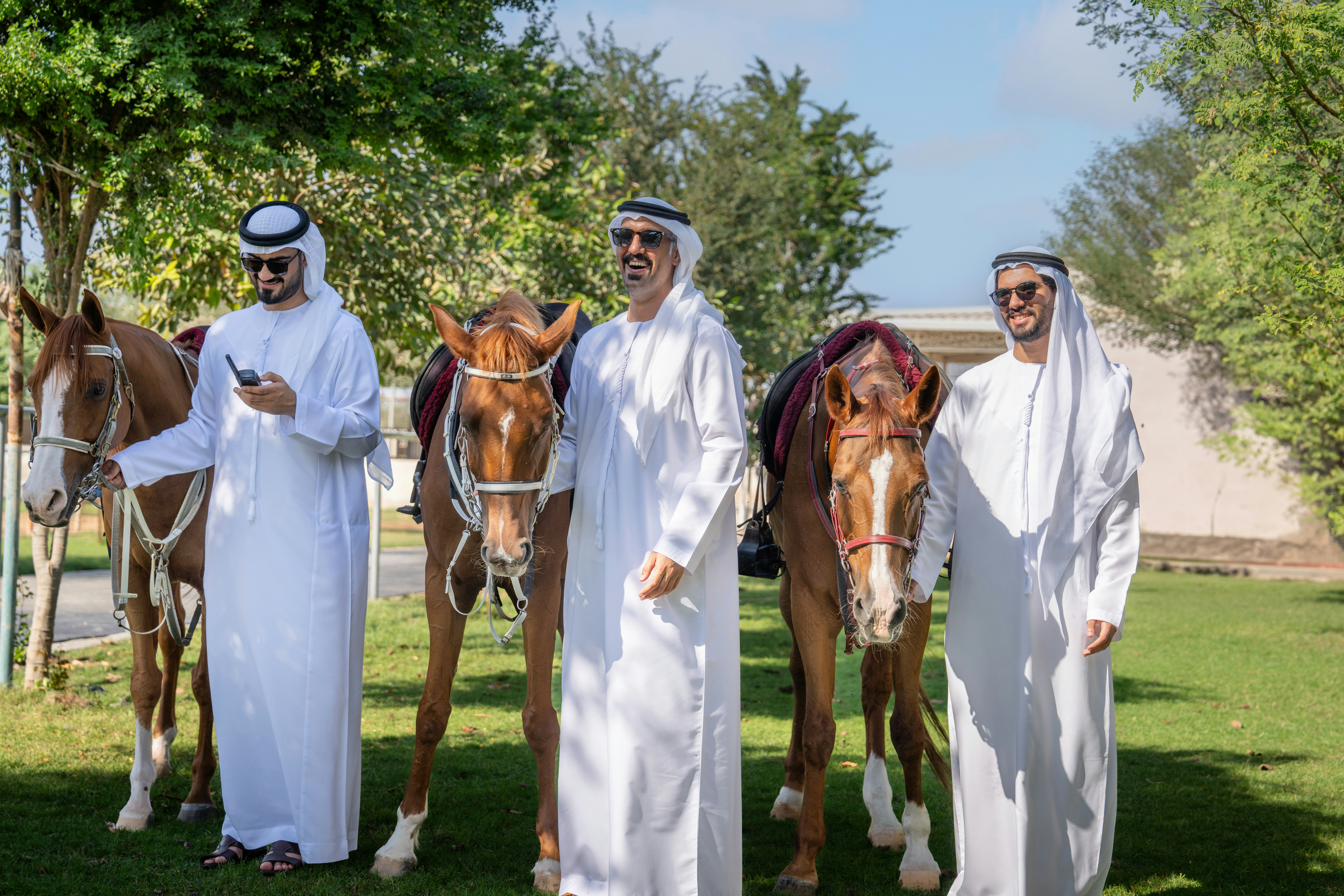 A group of men standing next to a brown horse