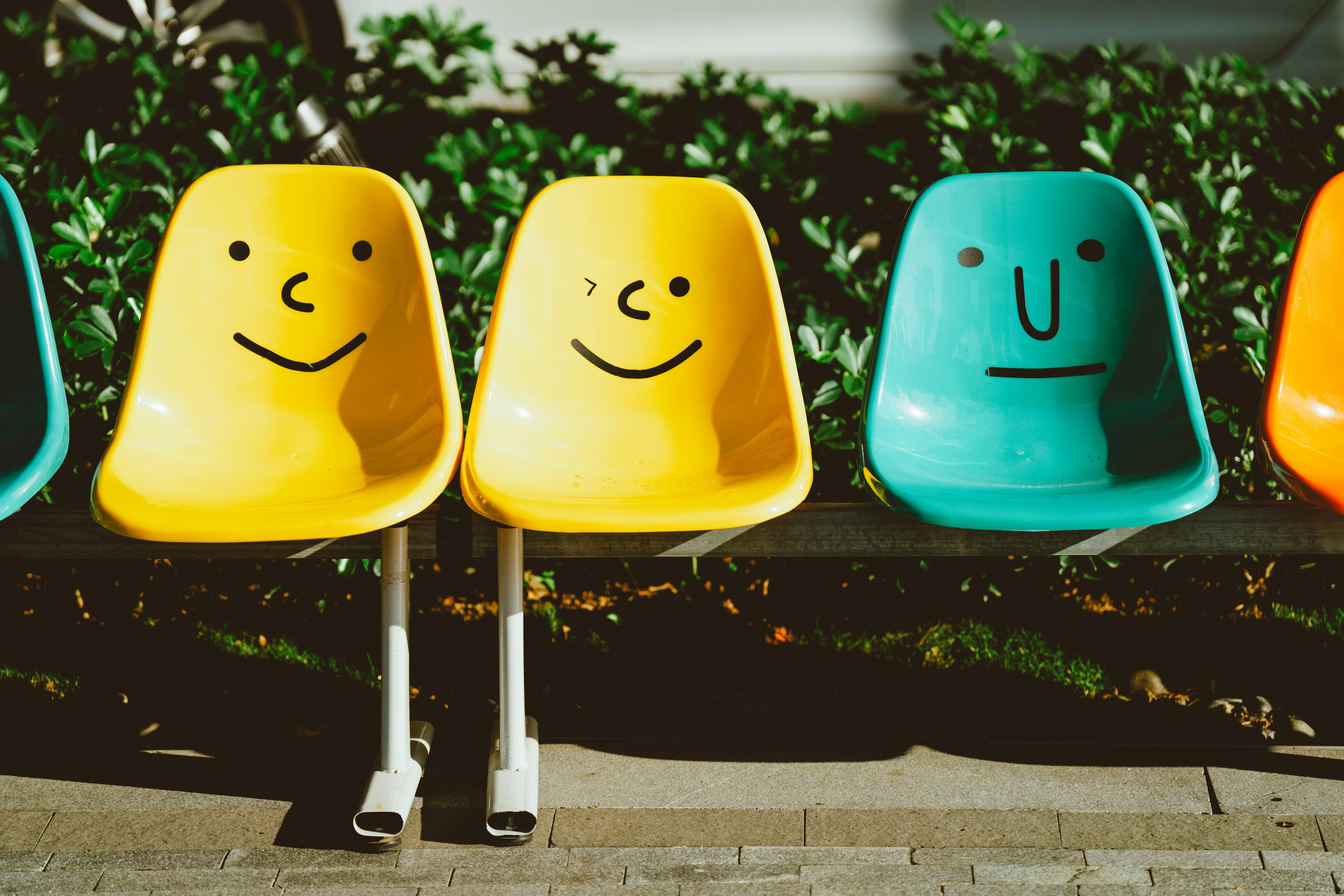 Colorful chairs with faces drawn on them